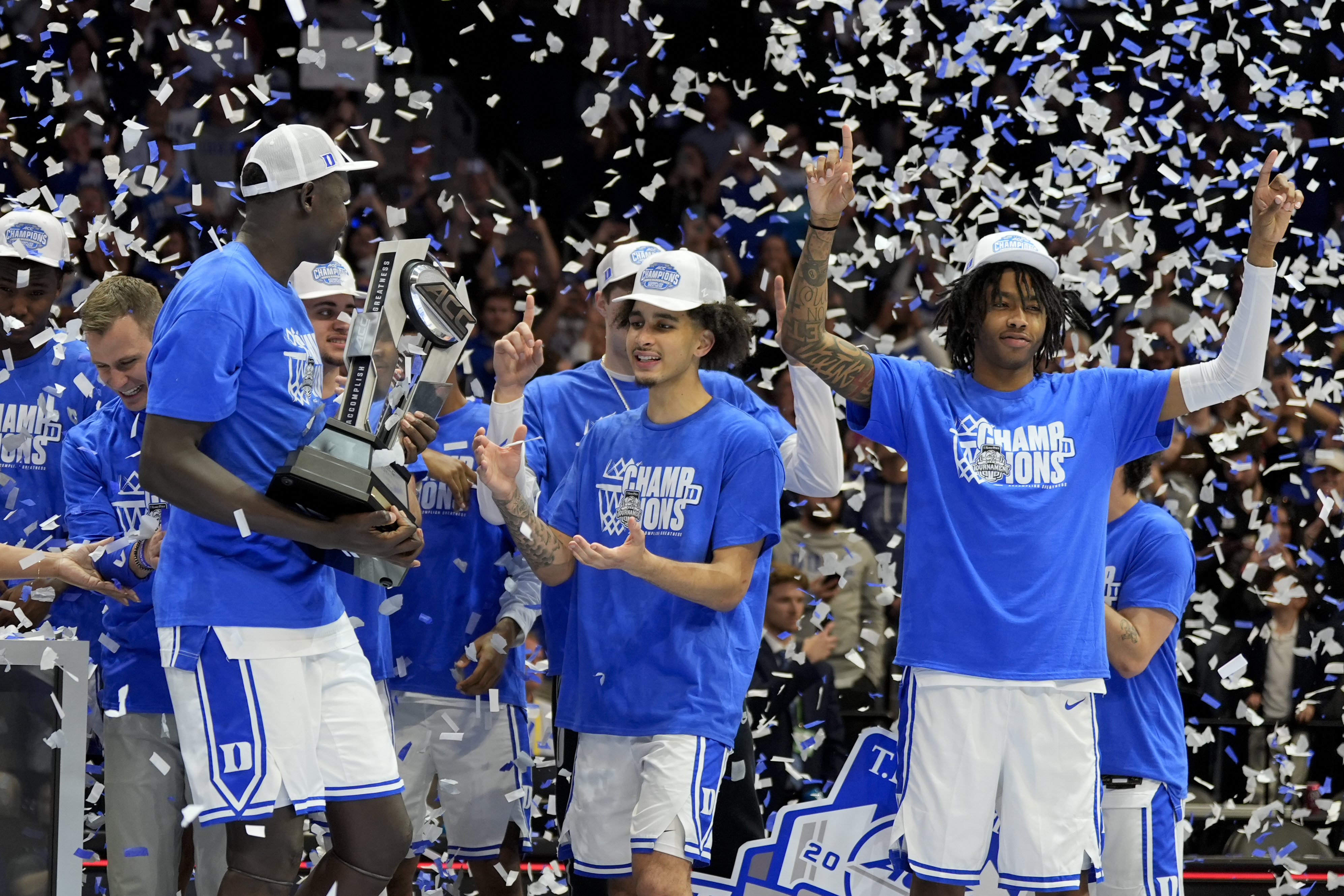 Duke celebrates with the trophy after their win against Louisville after an NCAA college basketball game in the championship of the Atlantic Coast Conference tournament, Saturday, March 15, 2025, in Charlotte, N.C. (AP Photo/Chris Carlson)