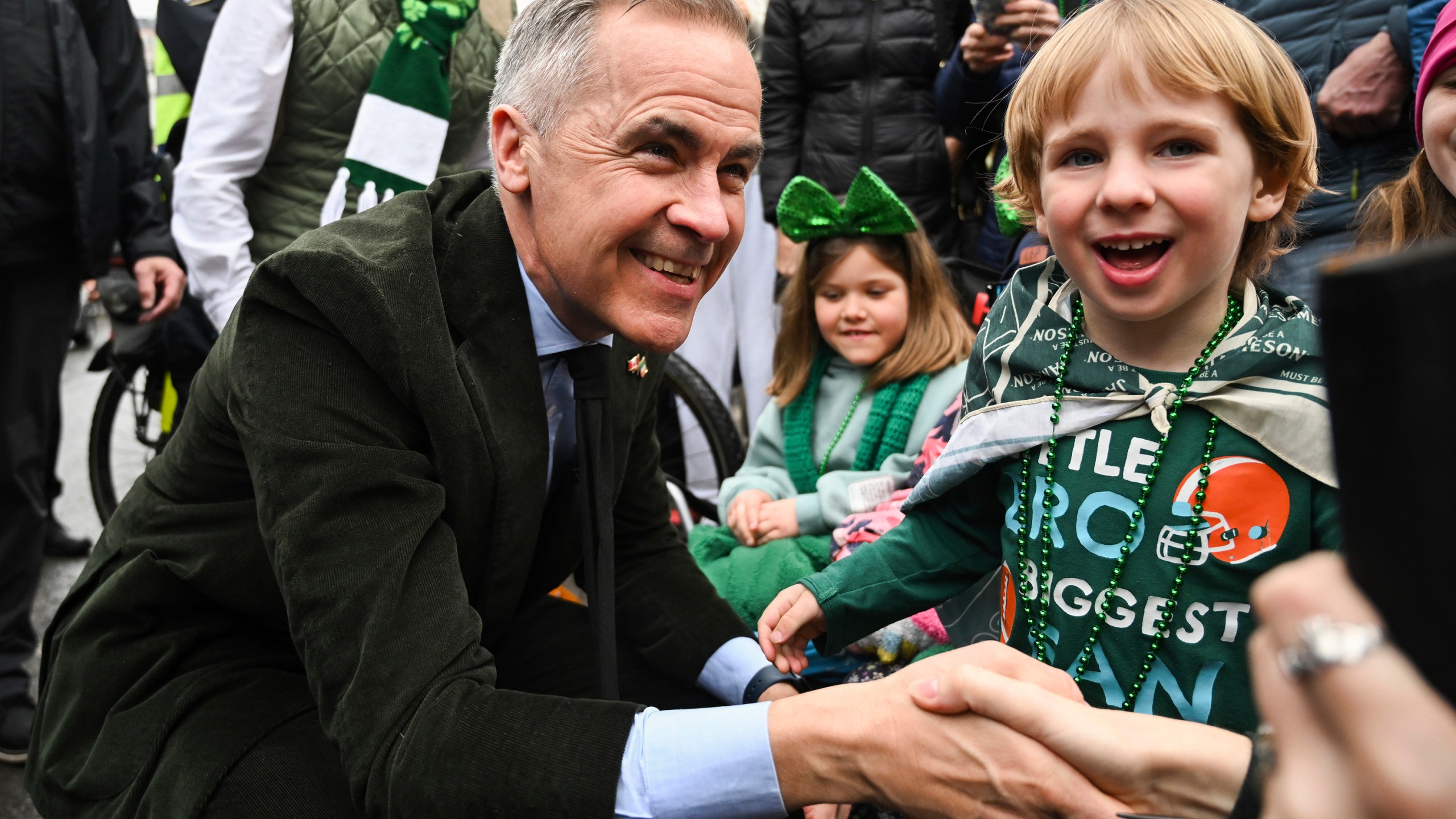 Prime Minister Mark Carney meets young members of the crowd during the annual St. Patrick's Day Parade in Montreal, Sunday March 16, 2025. (Graham Hughes /The Canadian Press via AP)