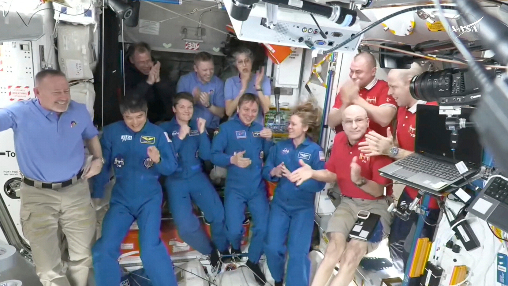 This image made from video by NASA shows astronauts greeting each other after a SpaceX capsule docked with the International Space Station, Sunday, March 16, 2025. Top row from left: Nick Hague, Alexander Gorbunov, Suni Williams, Alexei Ovchinin and Ivan Vagner. Bottom row from left: Butch Wilmore, Takuya Onishi, Anne McClain, Kirill Peskov, Nichole Ayers and Don Pettit. (NASA via AP)