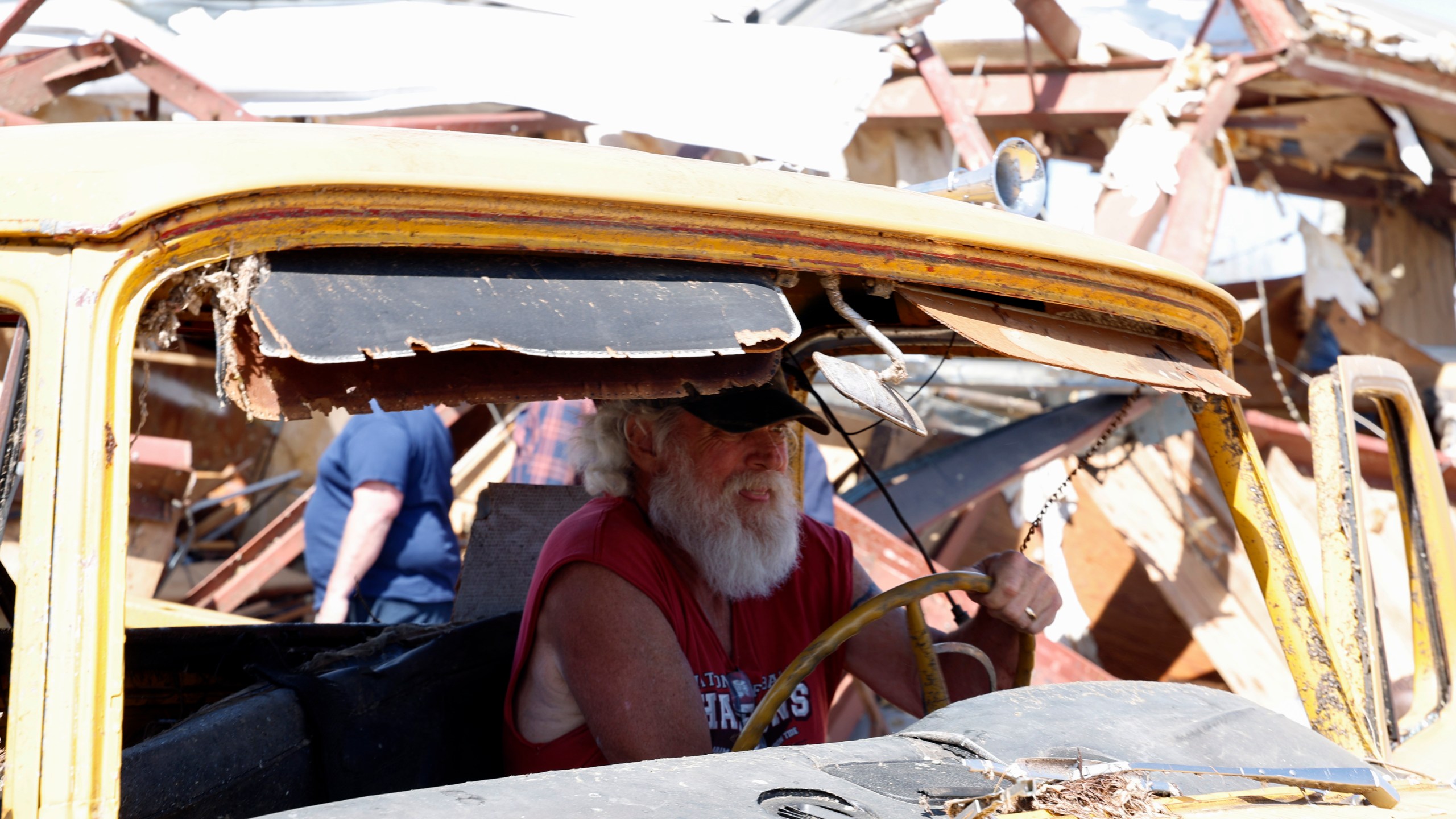 Tony Robertson drives a damaged pickup truck out of the way after a tornado passed through the area Sunday, March 16, 2025, in Plantersville, Ala. (AP Photo/Butch Dill)