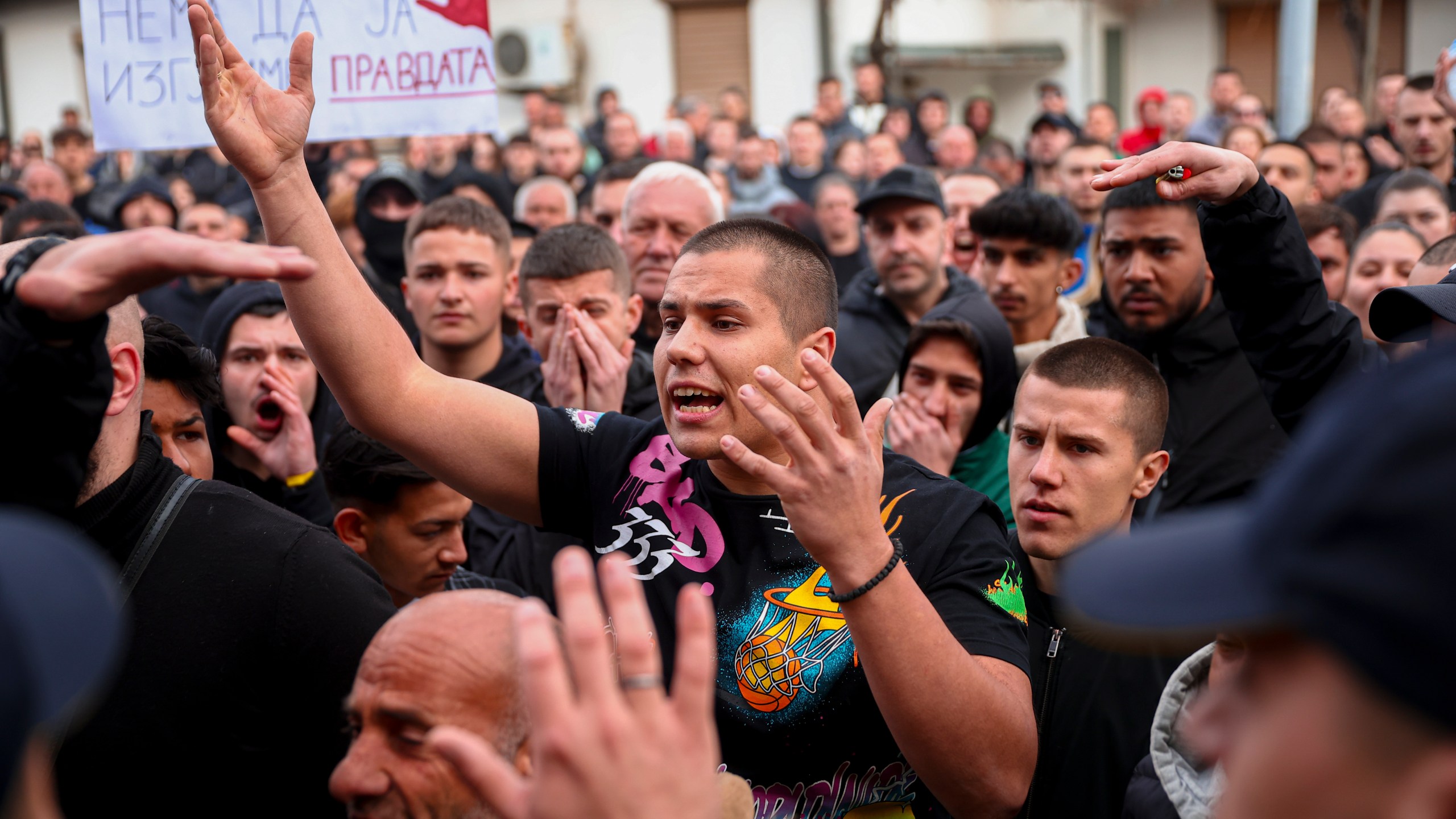 People argue with policemen, outside the home of the owner of a nightclub that was the scene of a massive fire, after a vigil for the victims in the town of Kocani, North Macedonia, Monday, March 17, 2025. (AP Photo/Armin Durgut)