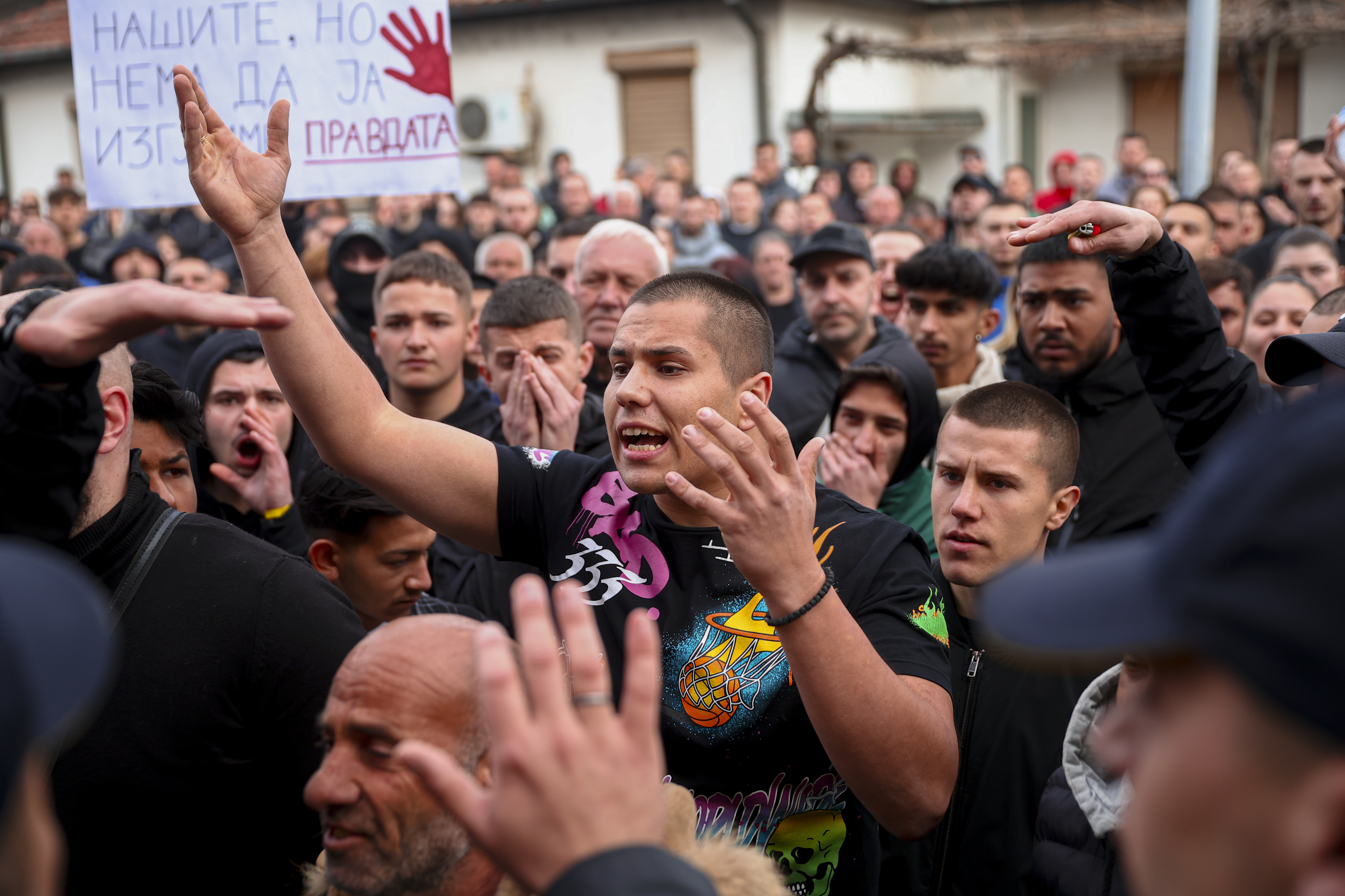 People argue with policemen, outside the home of the owner of a nightclub that was the scene of a massive fire, after a vigil for the victims in the town of Kocani, North Macedonia, Monday, March 17, 2025. (AP Photo/Armin Durgut)