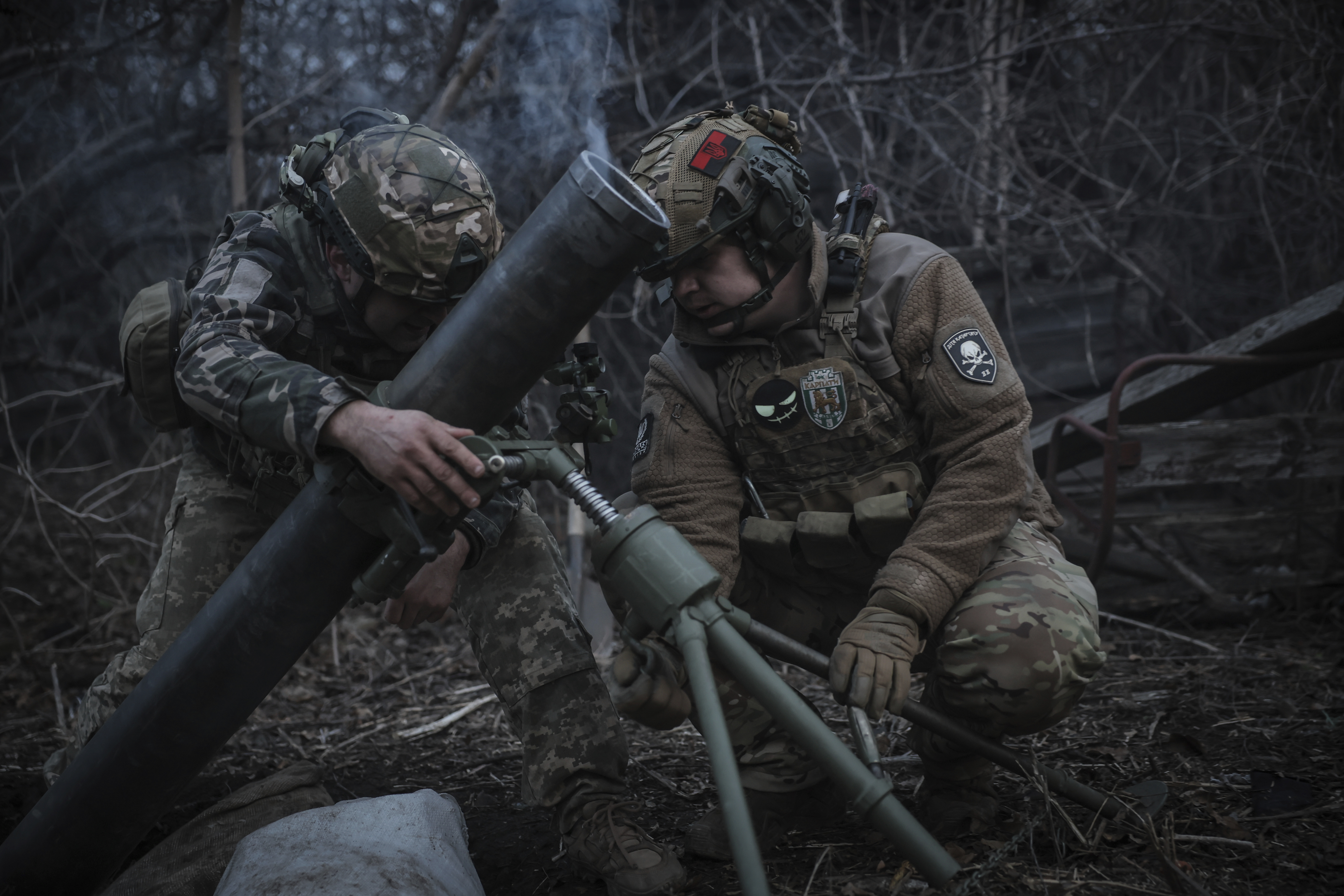 In this photo taken on March 16, 2025 and provided by Ukraine's 24th Mechanized Brigade press service, Ukrainian soldiers fire 120mm mortar towards Russian army positions near Chasiv Yar, Donetsk region, Ukraine, Sunday, March 16, 2025. (Oleg Petrasiuk/Ukraine's 24th Mechanized Brigade via AP)