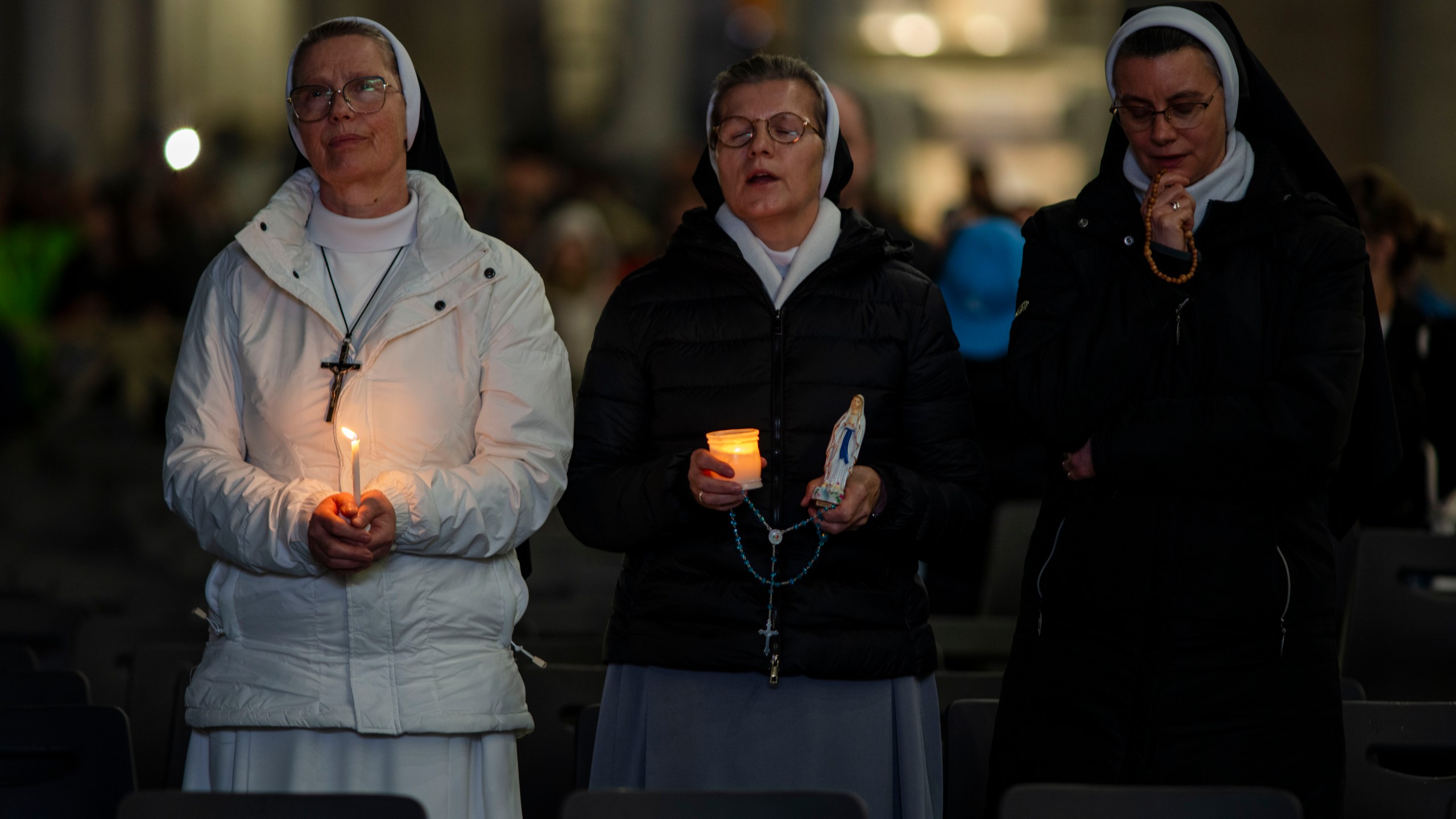 Nuns pray the rosary in St. Peter's Square at The Vatican, Sunday, Mar. 16, 2025, for the health of Pope Francis hospitalized at Agostino Gemelli Polyclinic in Rome where he is being treated for bilateral pneumonia since Feb.14. (AP Photo/Domenico Stinellis)