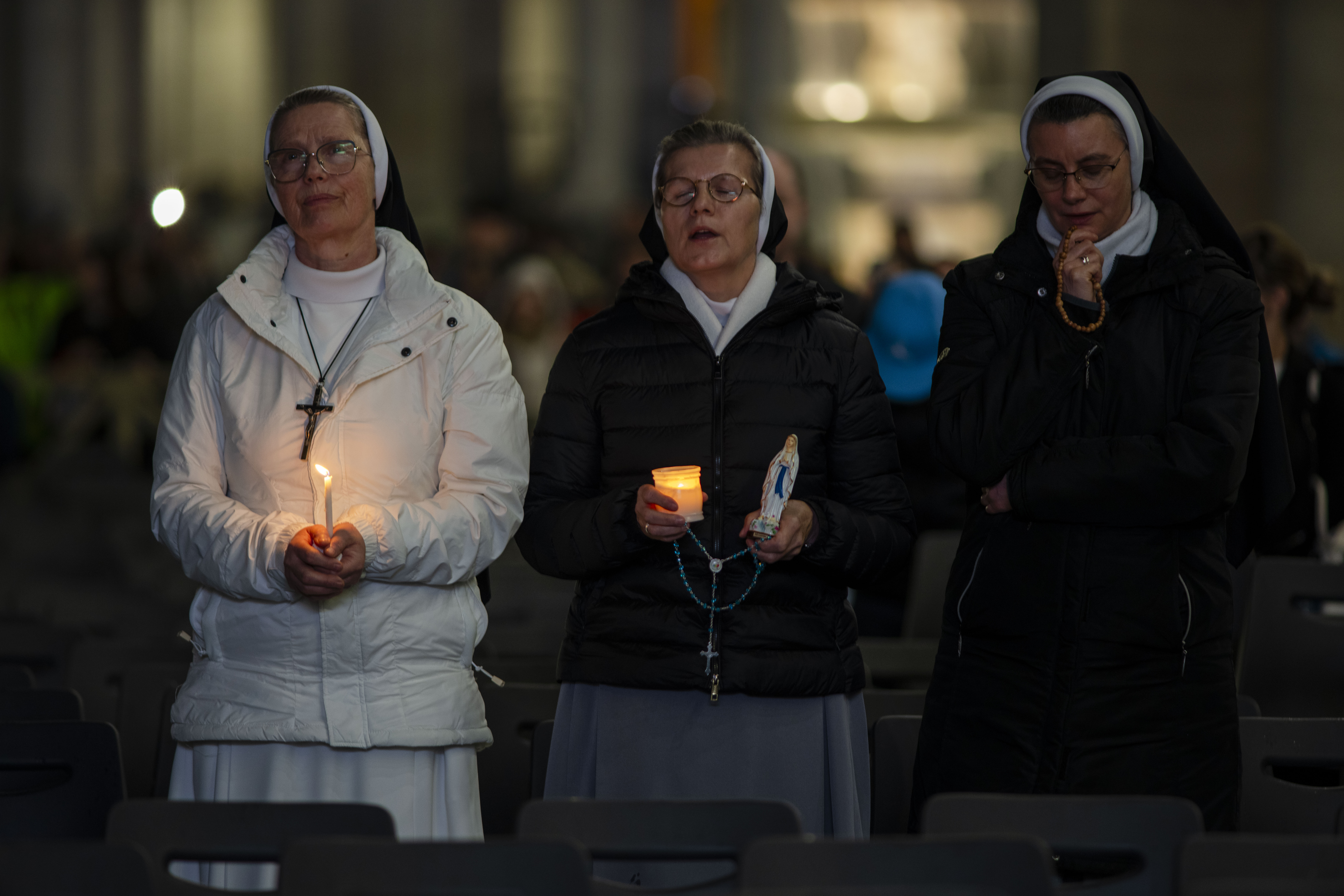 Nuns pray the rosary in St. Peter's Square at The Vatican, Sunday, Mar. 16, 2025, for the health of Pope Francis hospitalized at Agostino Gemelli Polyclinic in Rome where he is being treated for bilateral pneumonia since Feb.14. (AP Photo/Domenico Stinellis)