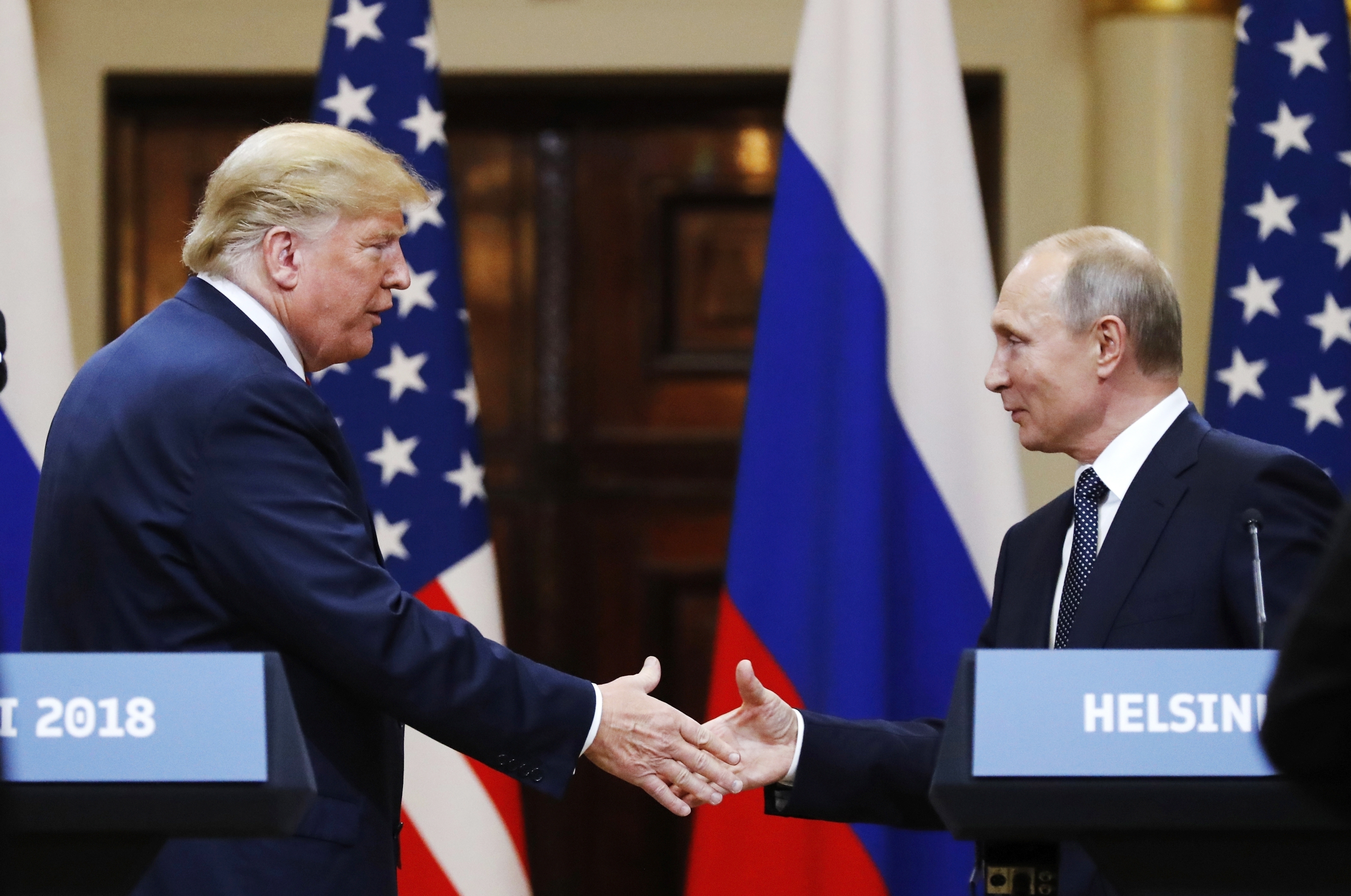 FILE - In this file photo taken on Monday, July 16, 2018, U.S. President Donald Trump shakes hand with Russian President Vladimir Putin at the end of the press conference after their meeting at the Presidential Palace in Helsinki, Finland. (AP Photo/Alexander Zemlianichenko, File)