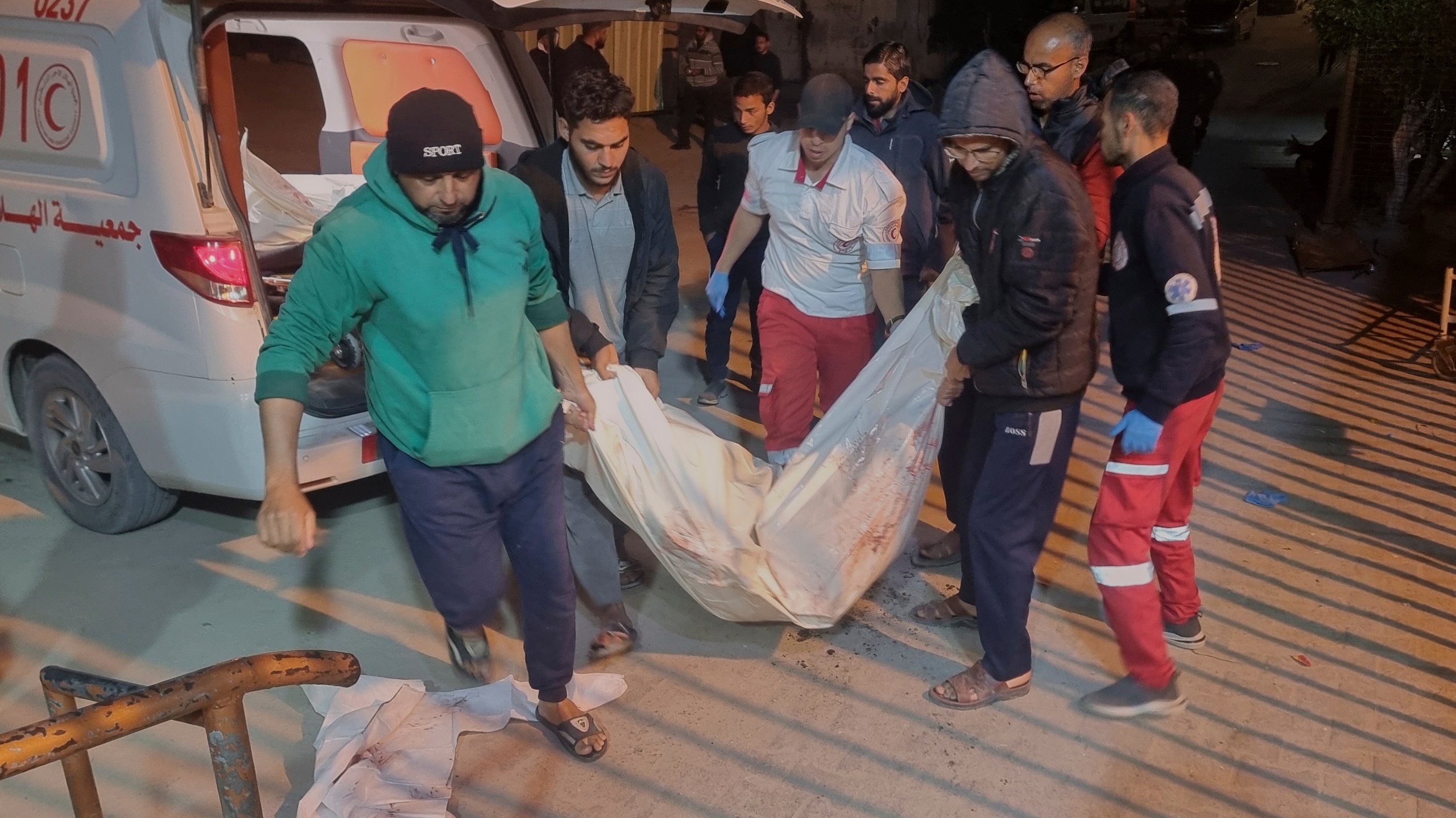 A dead person killed during an Israeli army strike is taken into the hospital in Khan Younis, southern Gaza Strip, Tuesday March 18, 2025.(AP Photo/ Mohammad Jahjouh)