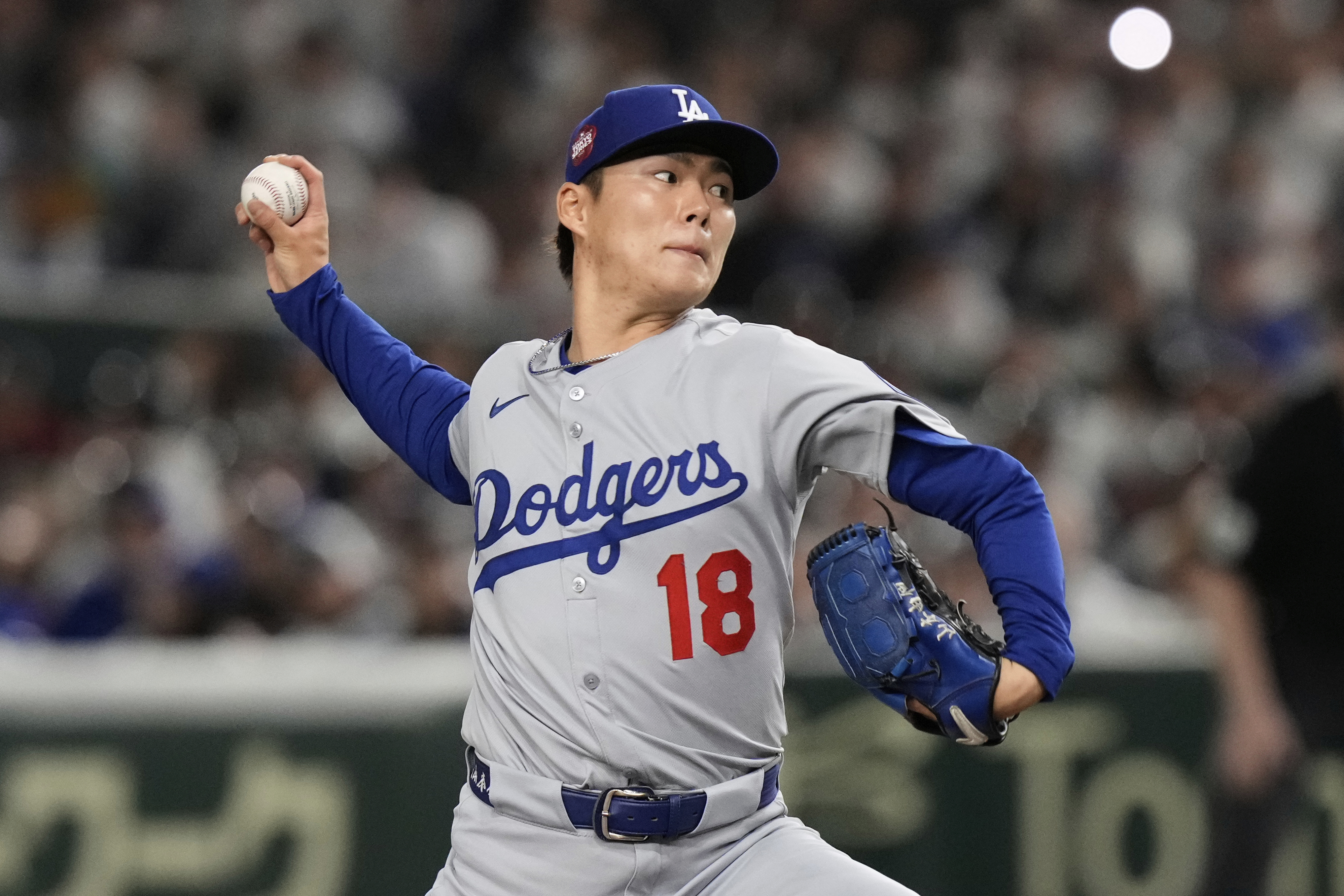 Los Angeles Dodgers starting pitcher Yoshinobu Yamamoto throws to the Chicago Cubs in the first inning of an MLB Japan Series baseball game in Tokyo, Japan, Tuesday, March 18, 2025. (AP Photo/Eugene Hoshiko)