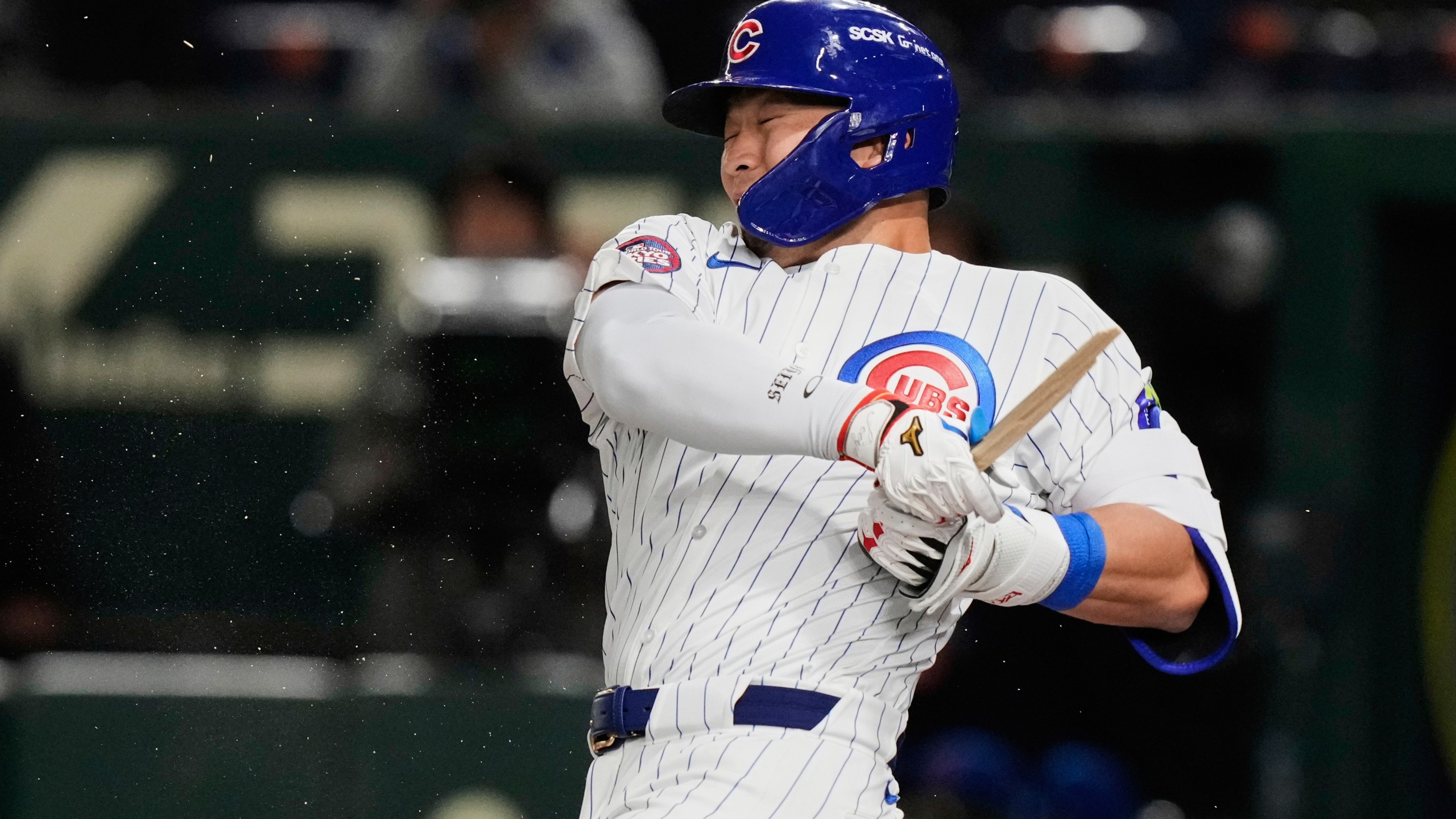 Chicago Cubs' Seiya Suzuki holds on to his broken bat after grounding out in the first inning of an MLB Japan Series baseball game against the Los Angeles Dodgers in Tokyo, Japan, Tuesday, March 18, 2025. (AP Photo/Eugene Hoshiko)