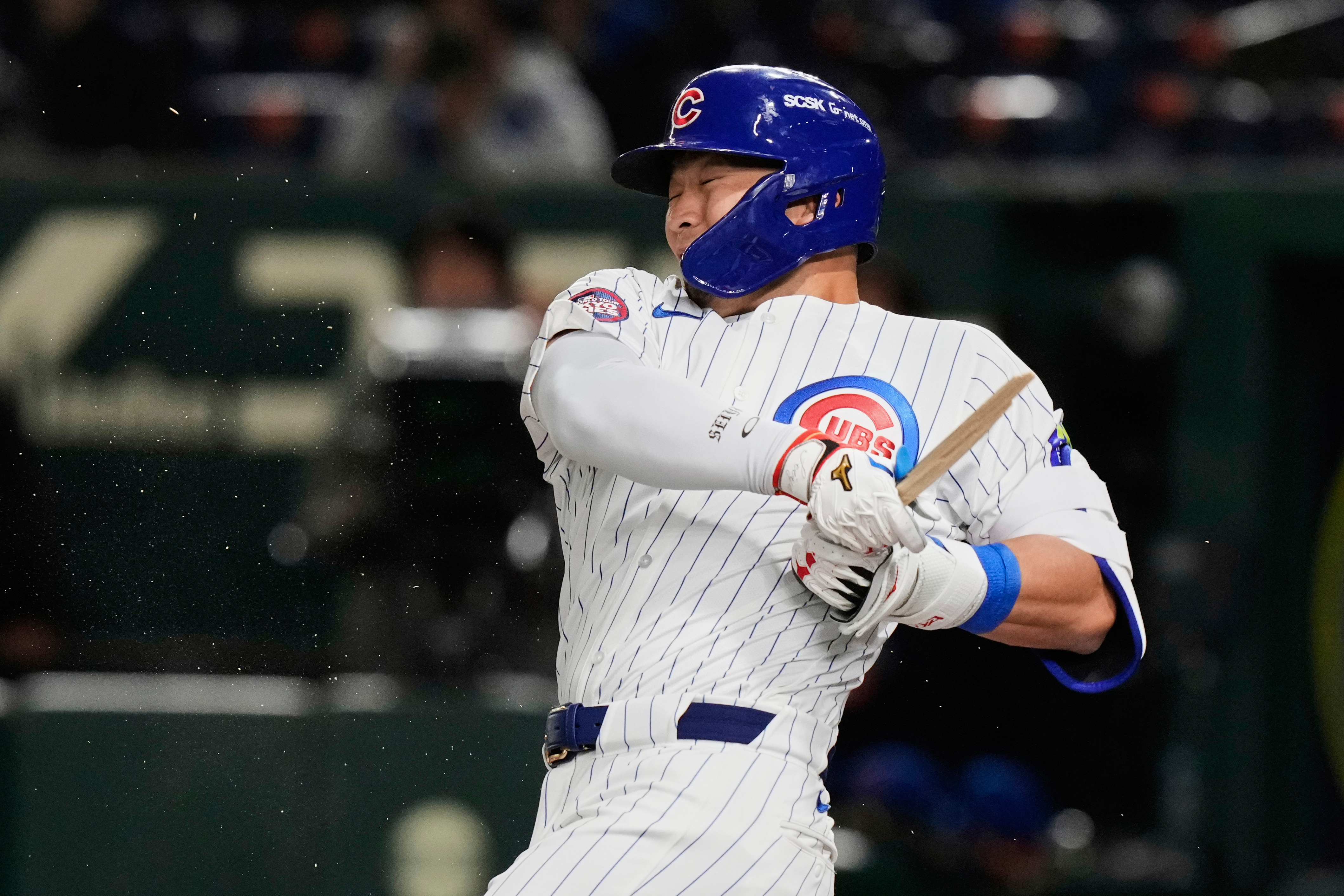 Chicago Cubs' Seiya Suzuki holds on to his broken bat after grounding out in the first inning of an MLB Japan Series baseball game against the Los Angeles Dodgers in Tokyo, Japan, Tuesday, March 18, 2025. (AP Photo/Eugene Hoshiko)