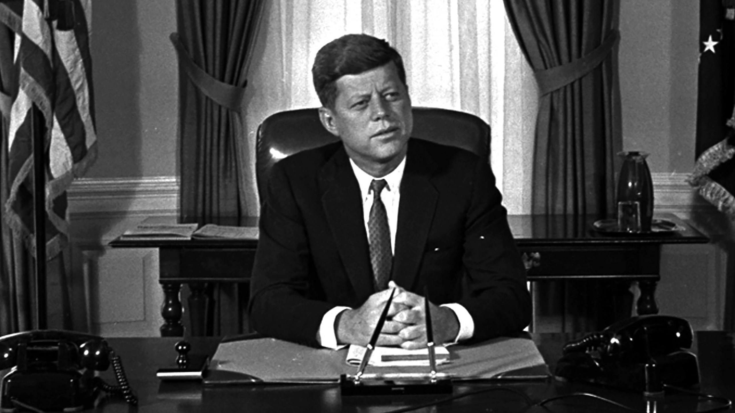 FILE - Newly-elected President Kennedy posed for first pictures at his White House desk, Jan. 21, 1961, before plunging into a busy round of conferences. (AP Photo/Bill Achatz, File)