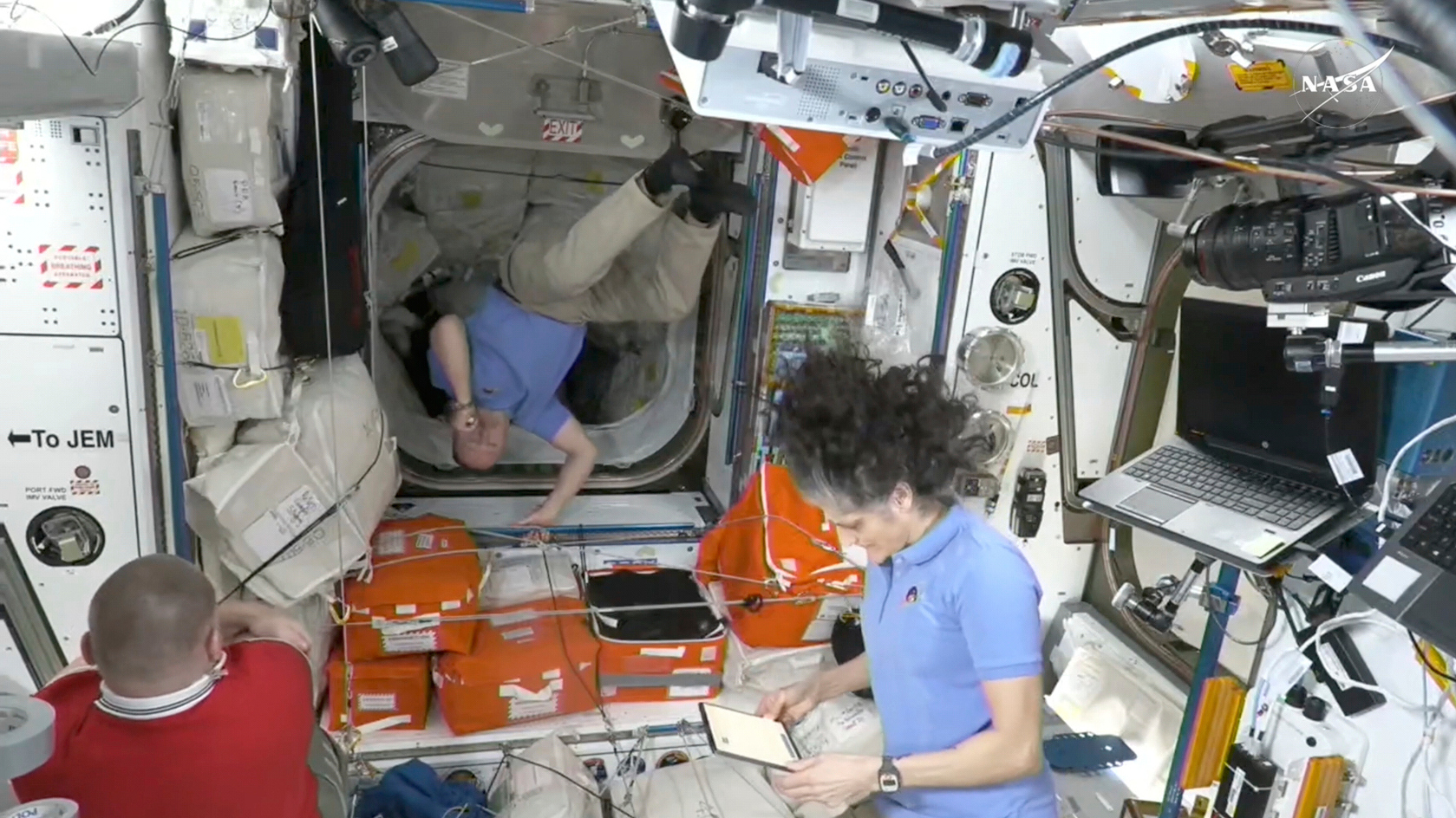 This image made from video by NASA shows Russian astronaut Alexei Ovchinin, left, Butch Wilmore, center, and Suni Williams wait to greet newly arrived astronauts after the SpaceX capsule docked with the International Space Station, Sunday, March 16, 2025. (NASA via AP)