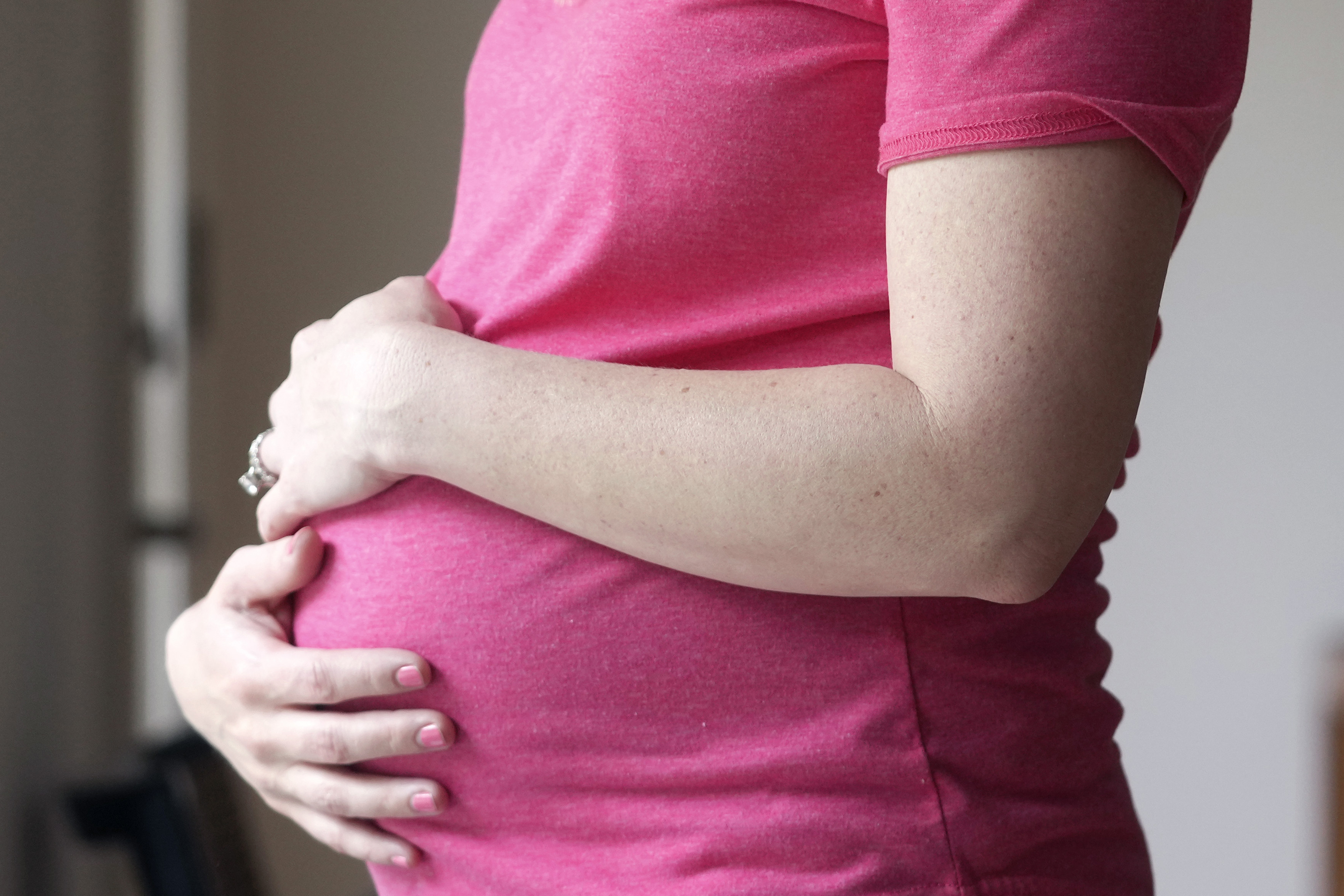 FILE - A pregnant woman stands for a portrait in Dallas, Thursday, May 18, 2023. (AP Photo/LM Otero, File)