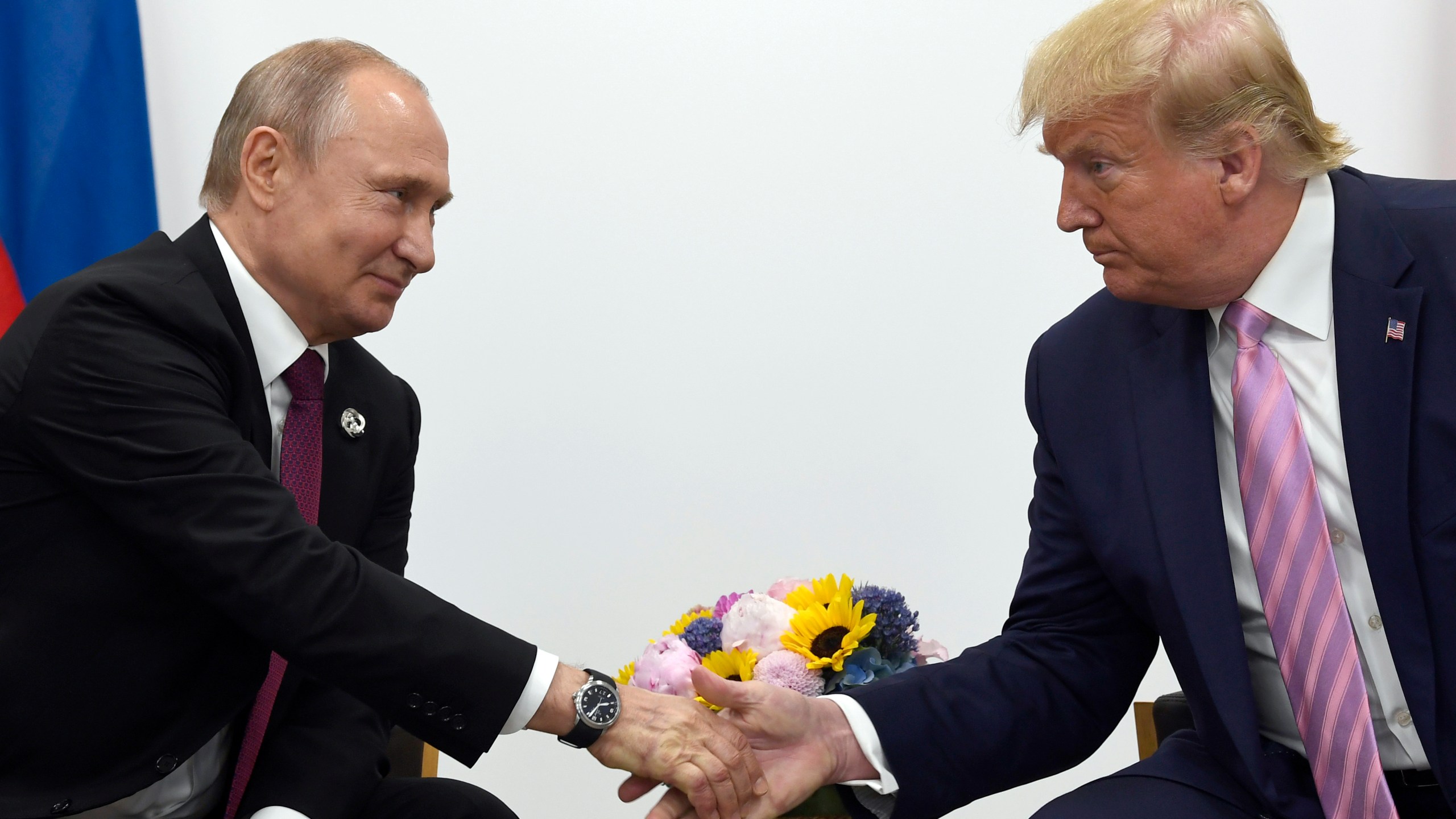 FILE - President Donald Trump, right, shakes hands with Russian President Vladimir Putin, left, during a bilateral meeting on the sidelines of the G-20 summit in Osaka, Japan, June 28, 2019. (AP Photo/Susan Walsh, File)