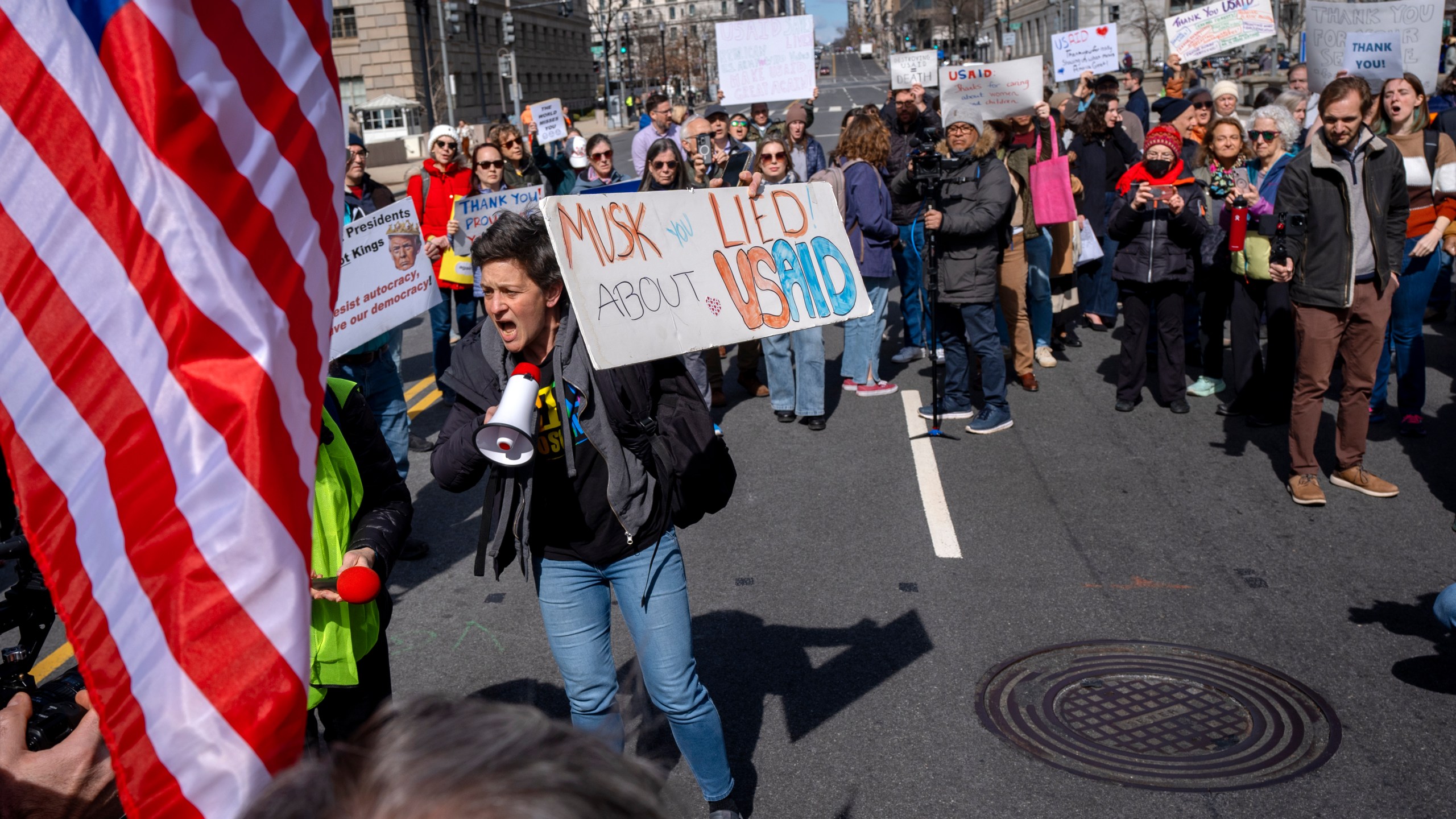 People rally on 14th St NW in support of fired USAID workers during a protest, Friday, Feb. 28, 2025, by the USAID headquarters in Washington. (AP Photo/Jacquelyn Martin)