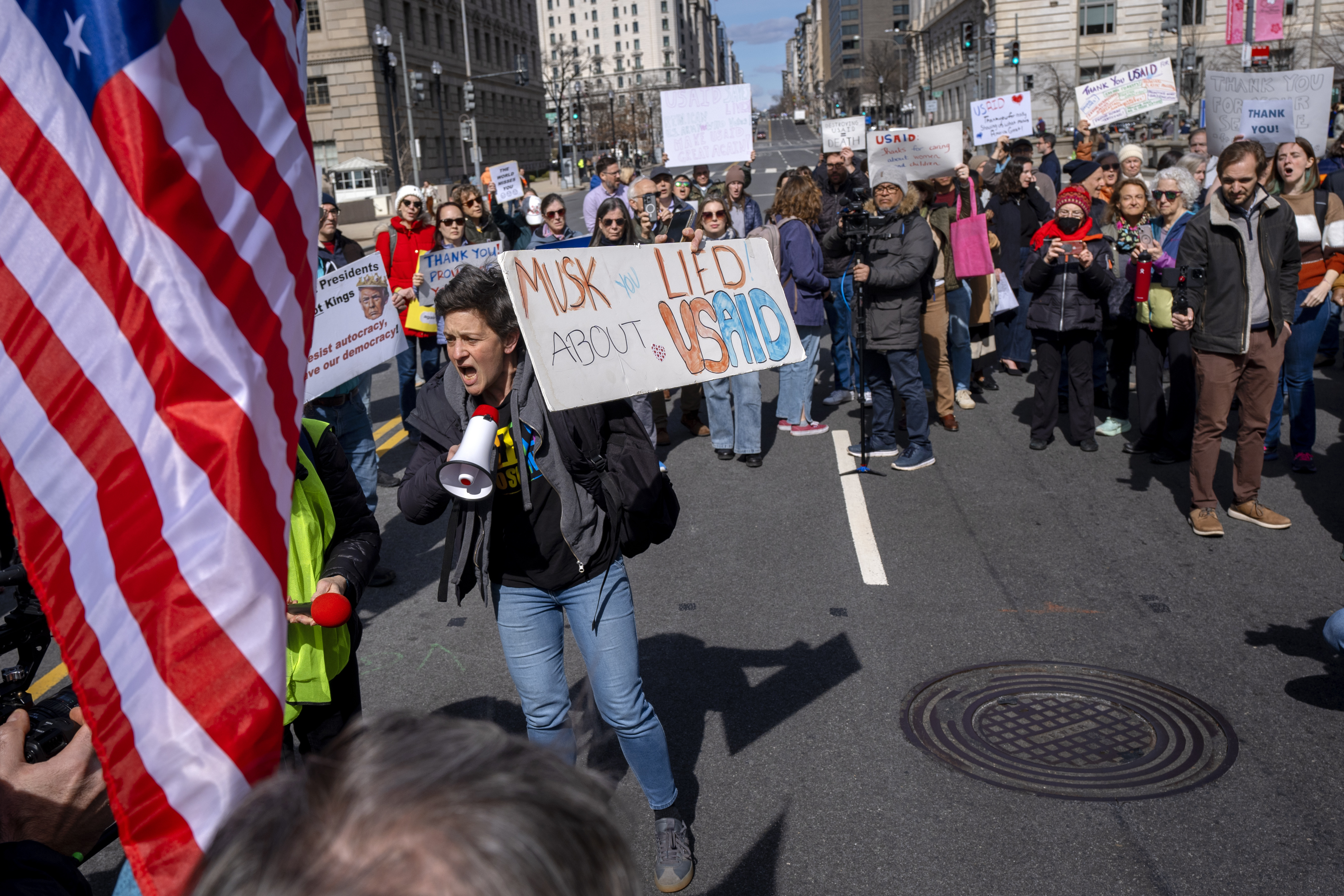 People rally on 14th St NW in support of fired USAID workers during a protest, Friday, Feb. 28, 2025, by the USAID headquarters in Washington. (AP Photo/Jacquelyn Martin)