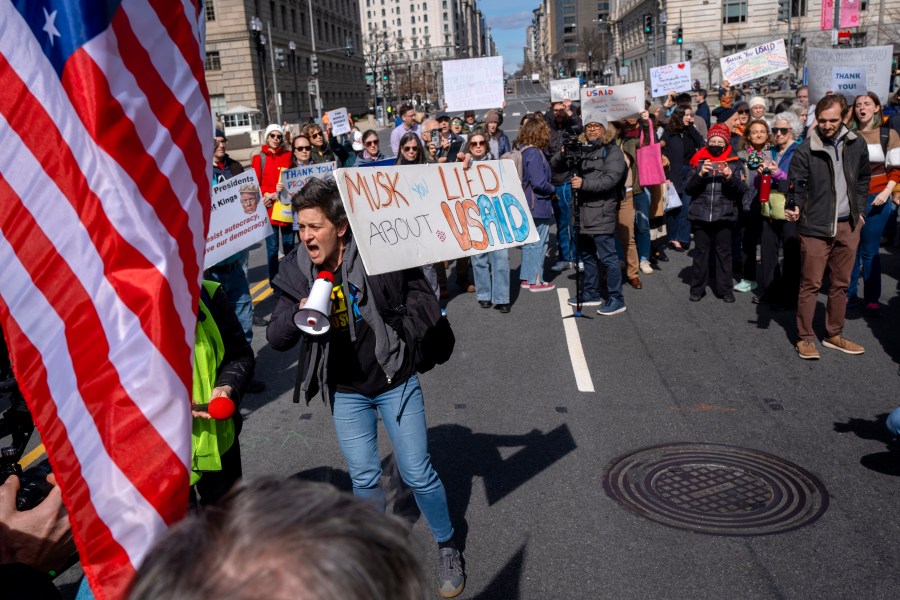 People rally on 14th St NW in support of fired USAID workers during a protest, Friday, Feb. 28, 2025, by the USAID headquarters in Washington. (AP Photo/Jacquelyn Martin)