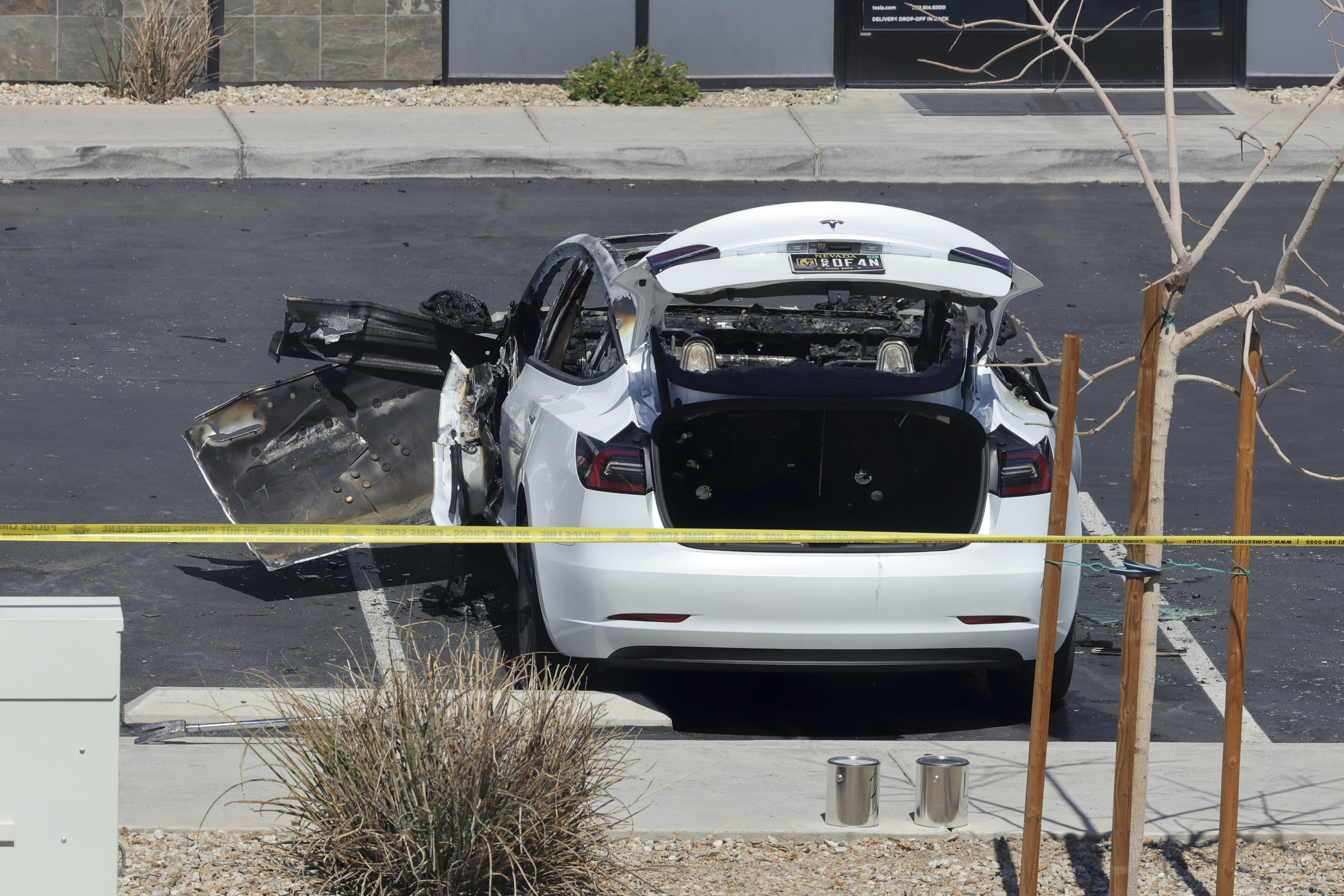 A burned Tesla vehicle is shown at a Tesla collision center Tuesday, March 18, 2025, in Las Vegas. (Steve Marcus/Las Vegas Sun via AP)