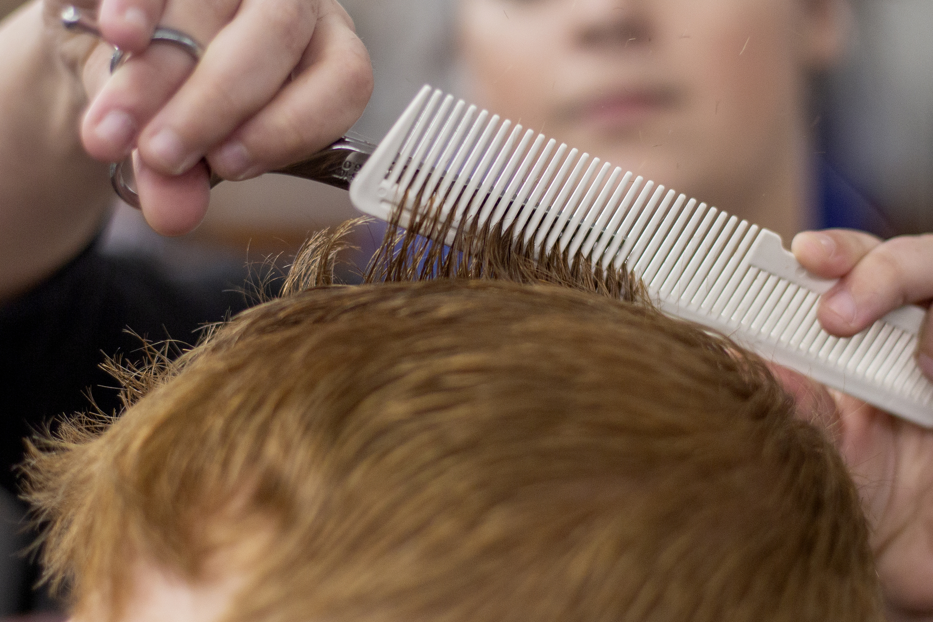 FILE - A barber cuts a client's hair at a barber shop in Chattanooga, Tenn., on Tuesday, March 17, 2020. (C.B. Schmelter/Chattanooga Times Free Press via AP, File)