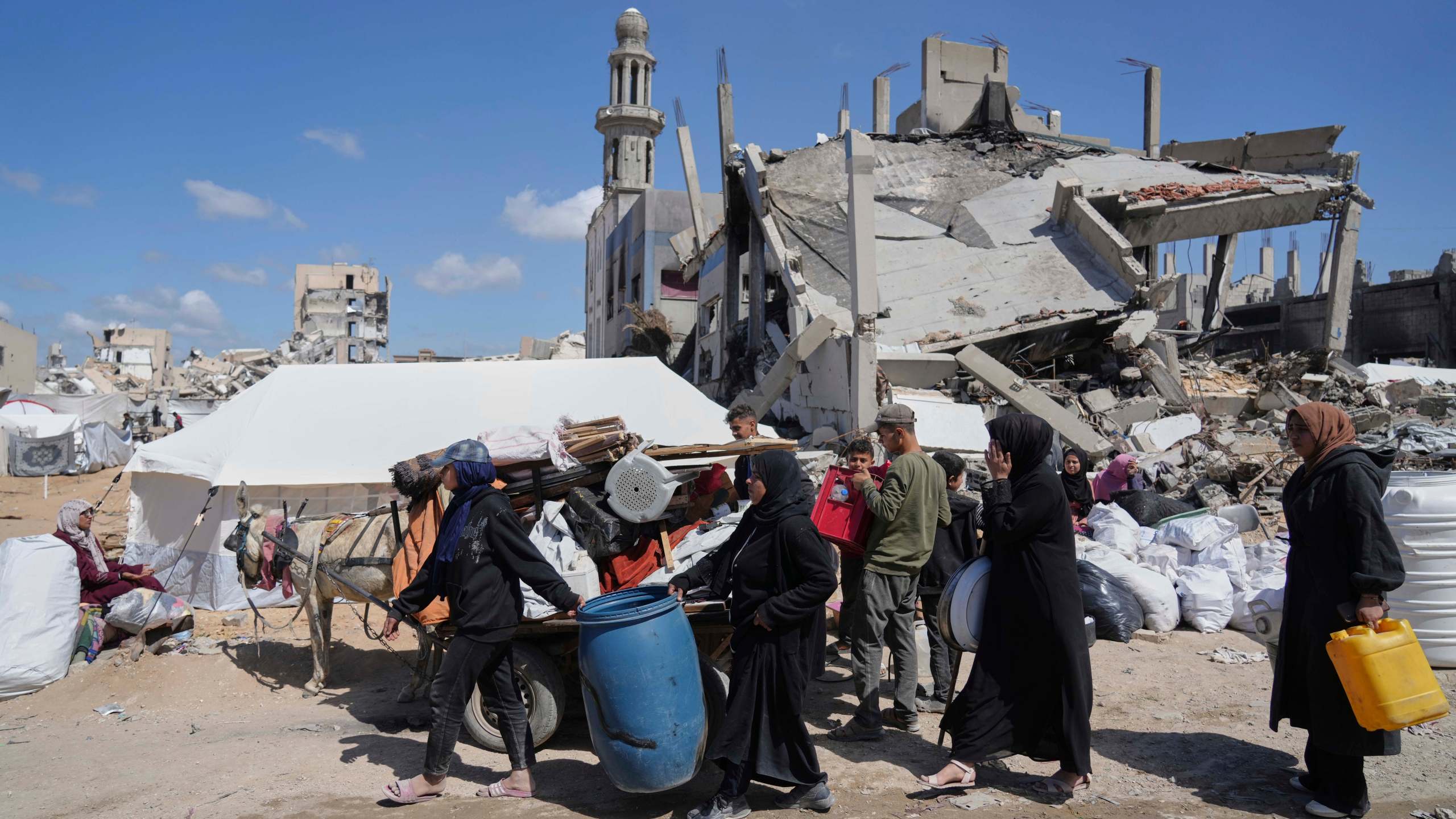 Displaced Palestinians, carrying their belongings traveling from Beit Hanoun to Jabaliya, a day after Israel's renewed offensive in the Gaza Strip, Wednesday, March 19, 2025. (AP Photo/Jehad Alshrafi)