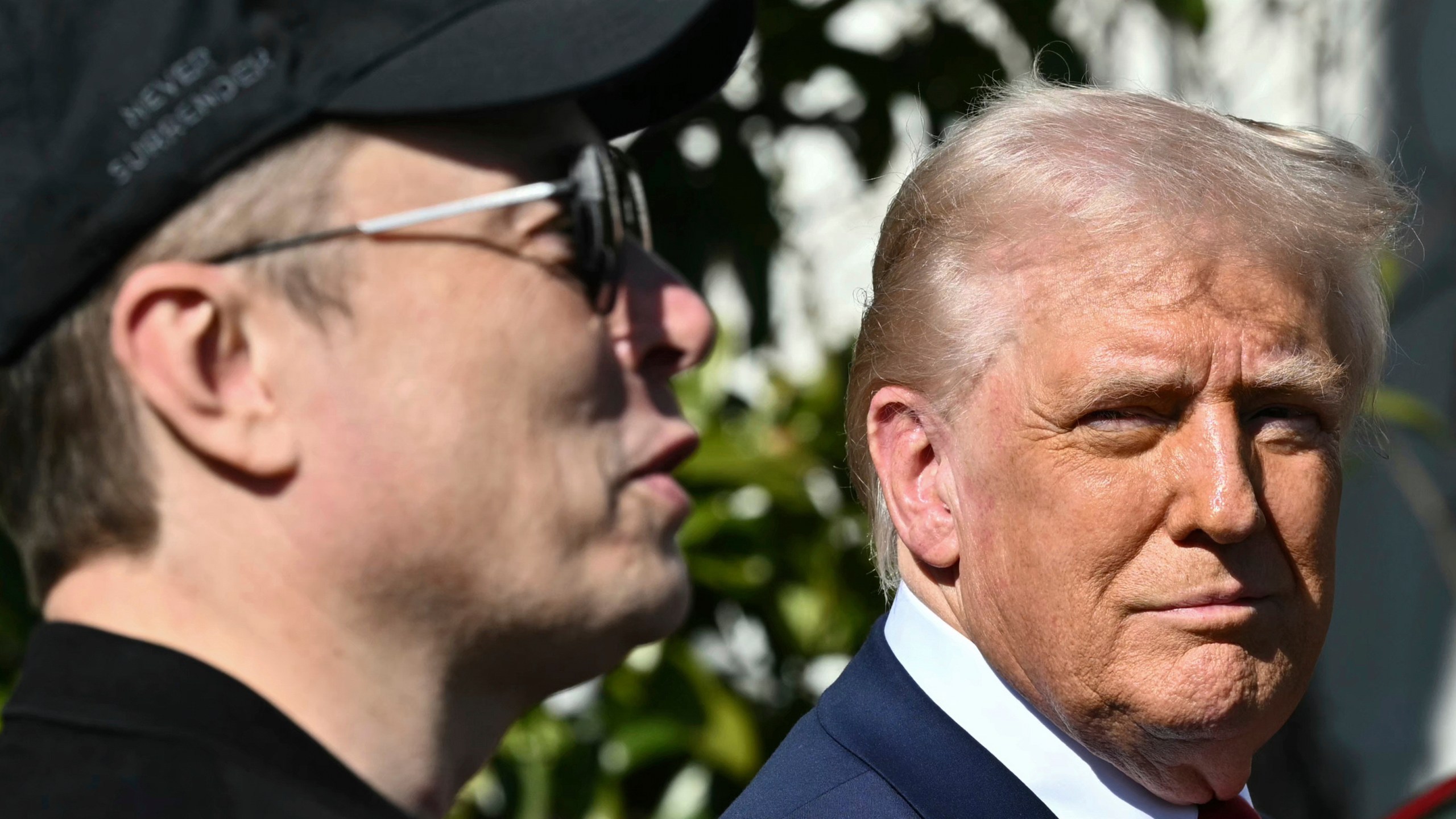 President Donald Trump and Tesla CEO Elon Musk talk with to reporters near Tesla vehicles on the South Lawn of the White House Tuesday, March 11, 2025, in Washington. (Pool via AP)