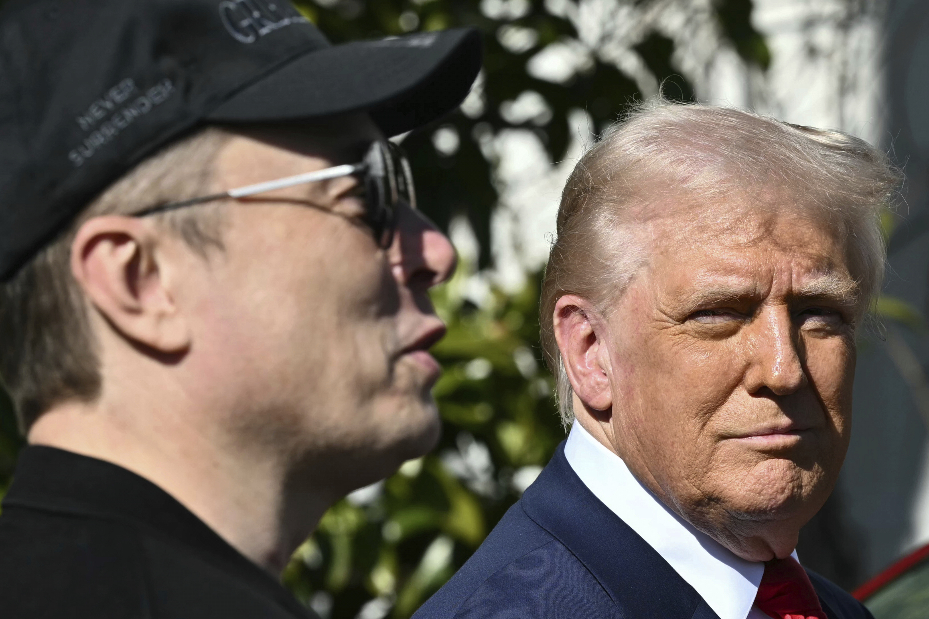 President Donald Trump and Tesla CEO Elon Musk talk with to reporters near Tesla vehicles on the South Lawn of the White House Tuesday, March 11, 2025, in Washington. (Pool via AP)