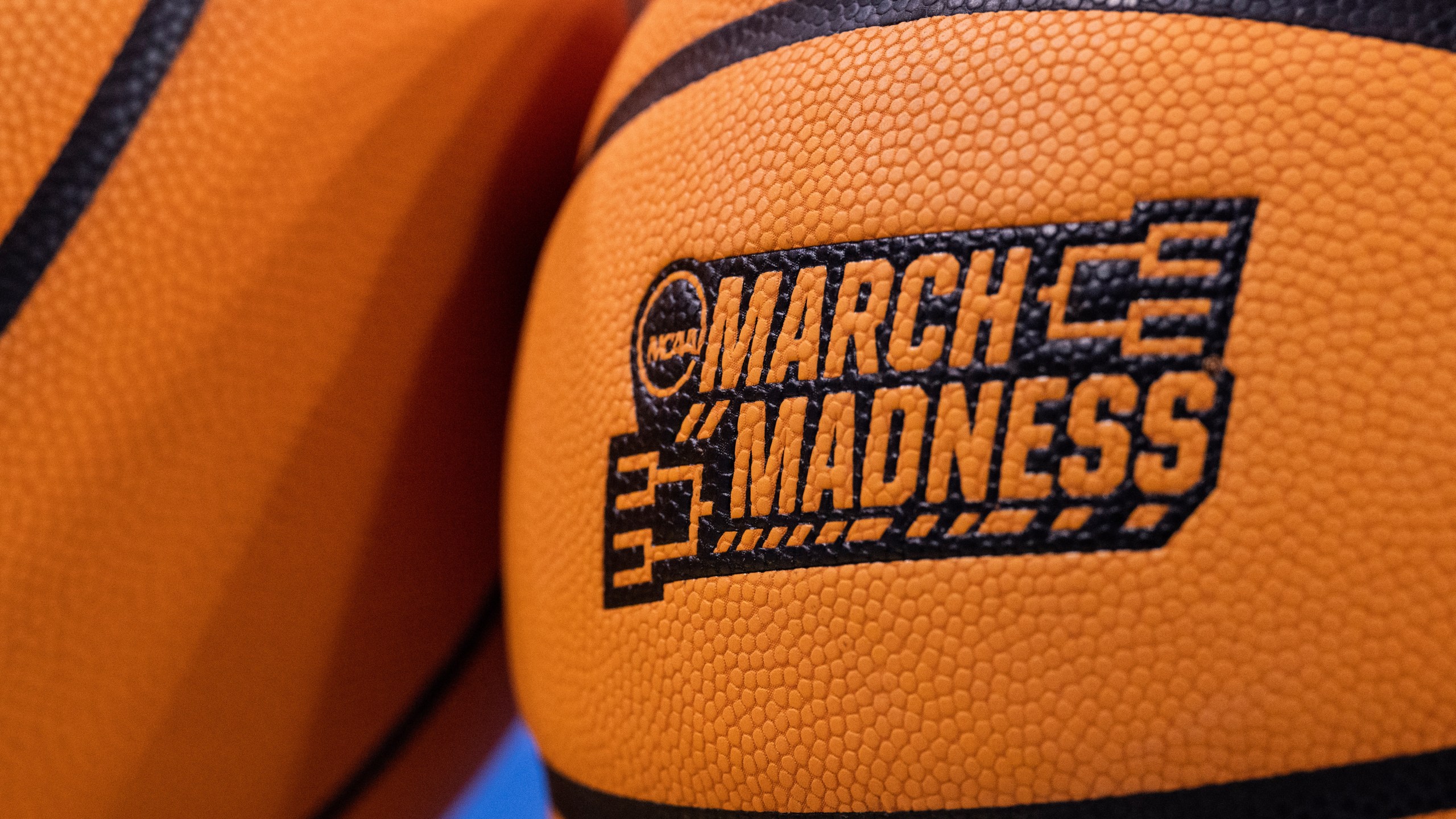 FILE - Two basketballs sit on the floor before a second round game between UCLA and Oklahoma in the NCAA college basketball tournament, Monday, March 20, 2023, in Los Angeles, Calif. (AP Photo/Kyusung Gong, File)