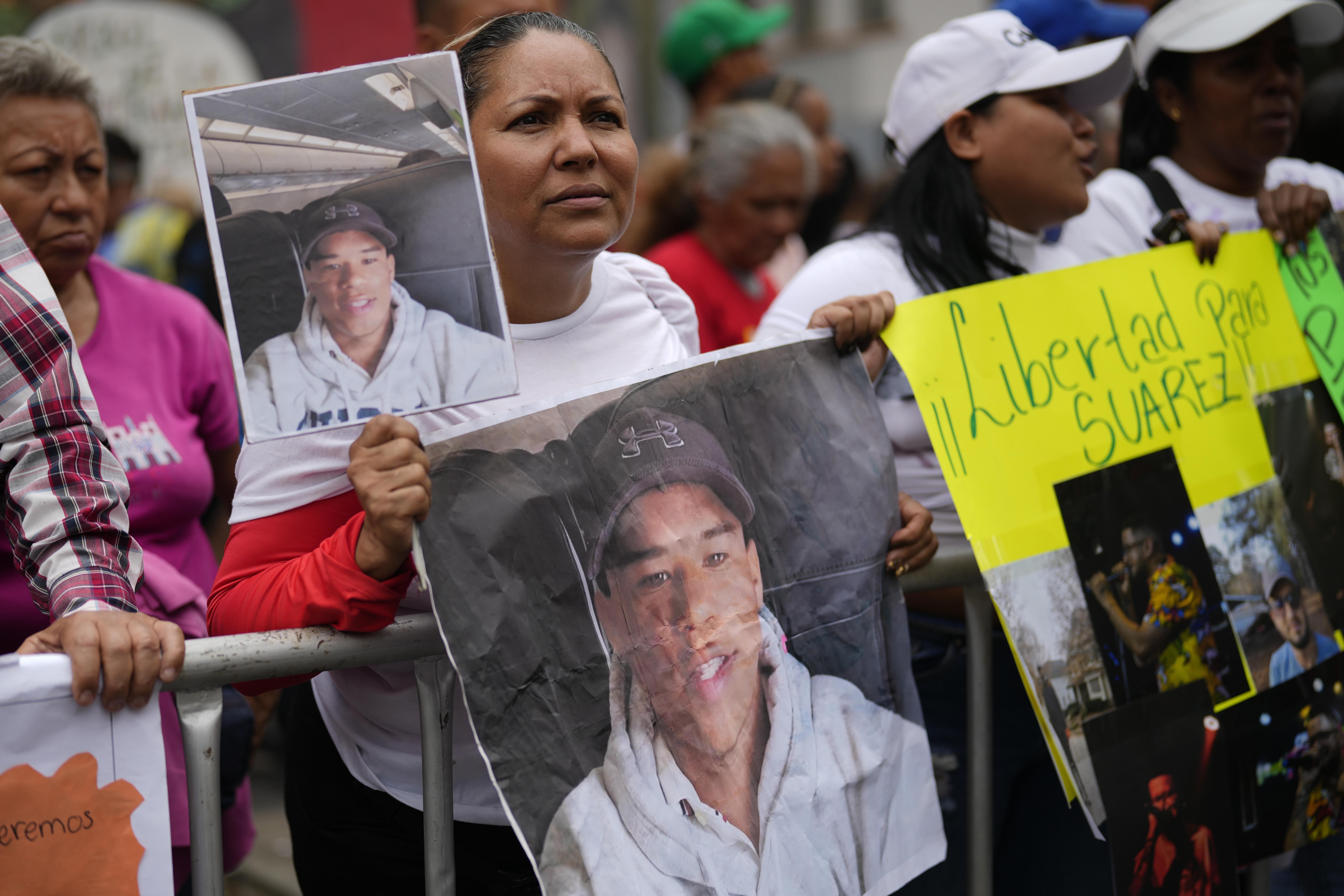 Jasmin Ramirez holds a photo of her son, Angelo Escalona, at a government-organized rally protesting the deportation of alleged members of the Venezuelan Tren de Aragua gang, who were transferred to an El Salvador prison, in Caracas, Venezuela, Tuesday, March 18, 2025. Ramirez said she hadn't heard from her son since he called to say he was with a group of migrants about to be deported on March 14. (AP Photo/Ariana Cubillos)