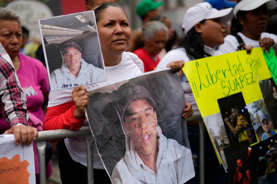 Jasmin Ramirez holds a photo of her son, Angelo Escalona, at a government-organized rally protesting the deportation of alleged members of the Venezuelan Tren de Aragua gang, who were transferred to an El Salvador prison, in Caracas, Venezuela, Tuesday, March 18, 2025. Ramirez said she hadn't heard from her son since he called to say he was with a group of migrants about to be deported on March 14. (AP Photo/Ariana Cubillos)