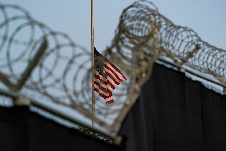 FILE - In this Aug. 29, 2021, file photo reviewed by U.S. military officials, a flag flies at half-staff as seen from Camp Justice in Guantanamo Bay Naval Base, Cuba. (AP Photo/Alex Brandon, File)