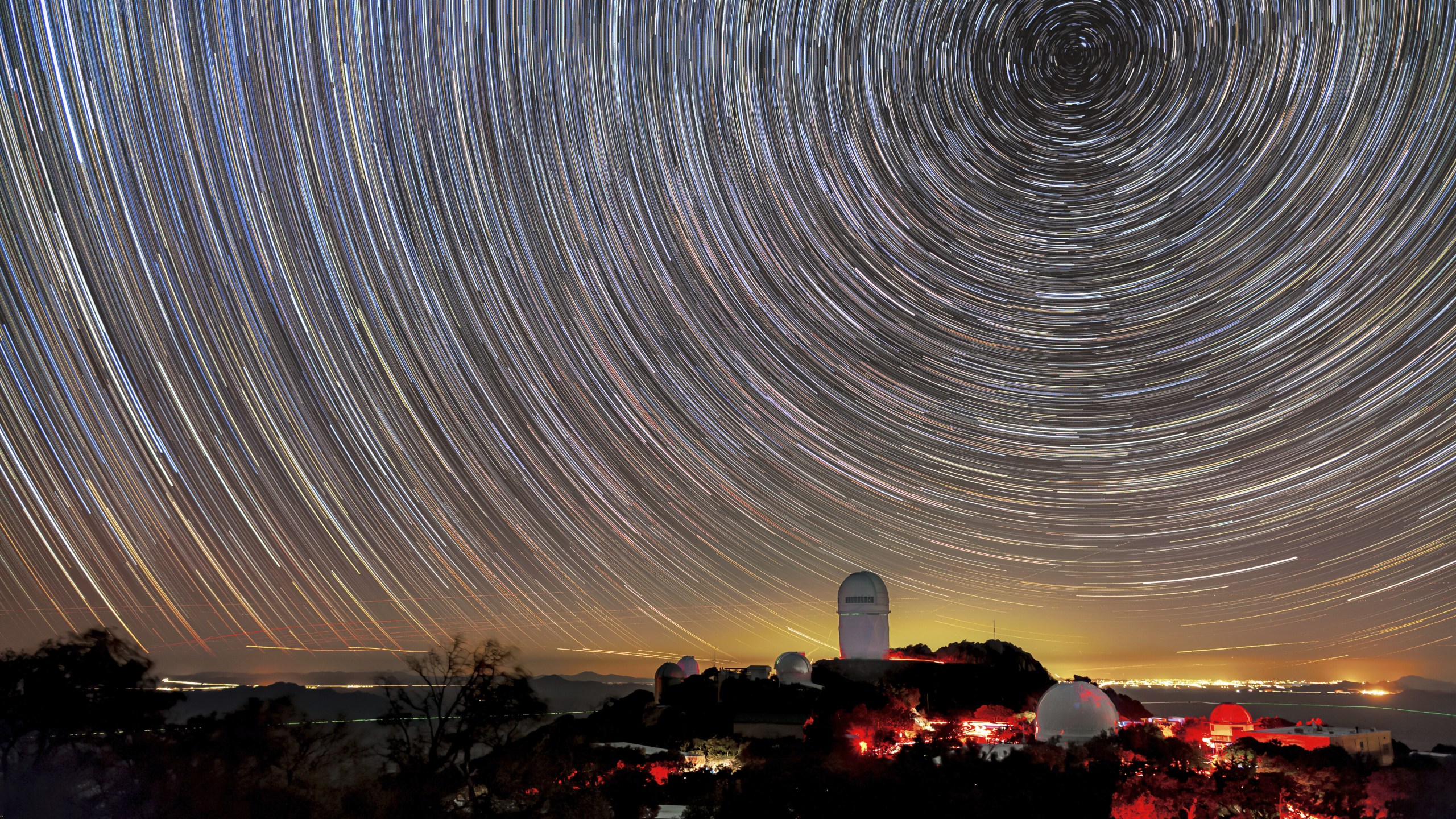 This image provided by NSF’s NOIRLab shows the trails of stars above Kitt Peak National Observatory, where a telescope is mapping the universe to study a mysterious force called dark energy. (NSF’s NoirLab via AP)