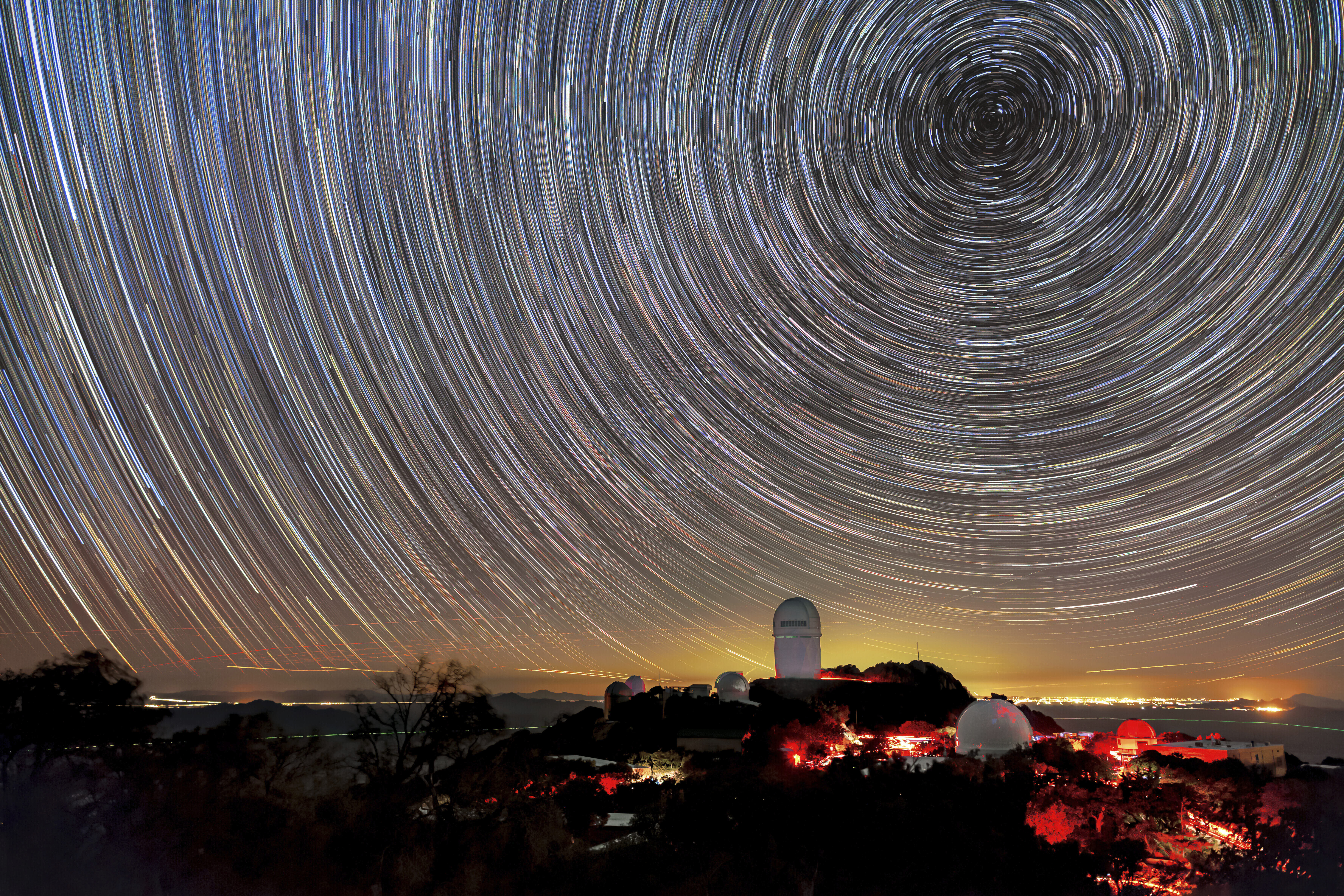 This image provided by NSF’s NOIRLab shows the trails of stars above Kitt Peak National Observatory, where a telescope is mapping the universe to study a mysterious force called dark energy. (NSF’s NoirLab via AP)