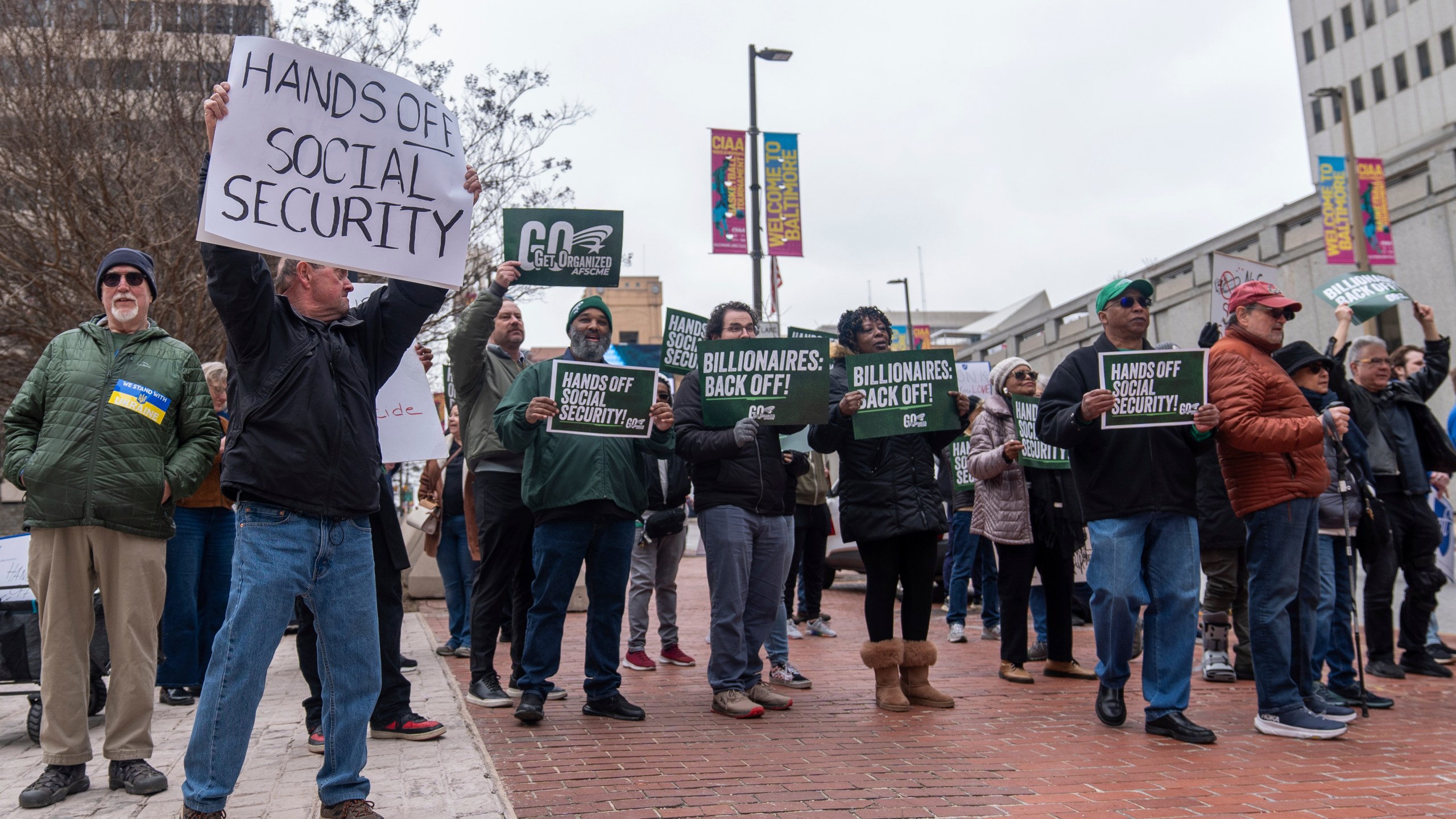 Demonstrators gather outside of the Edward A. Garmatz United States District Courthouse in Baltimore, on Friday, March 14, 2025, before a hearing regarding the Department of Government Efficiency's access to Social Security data. (AP Photo/Stephanie Scarbrough)