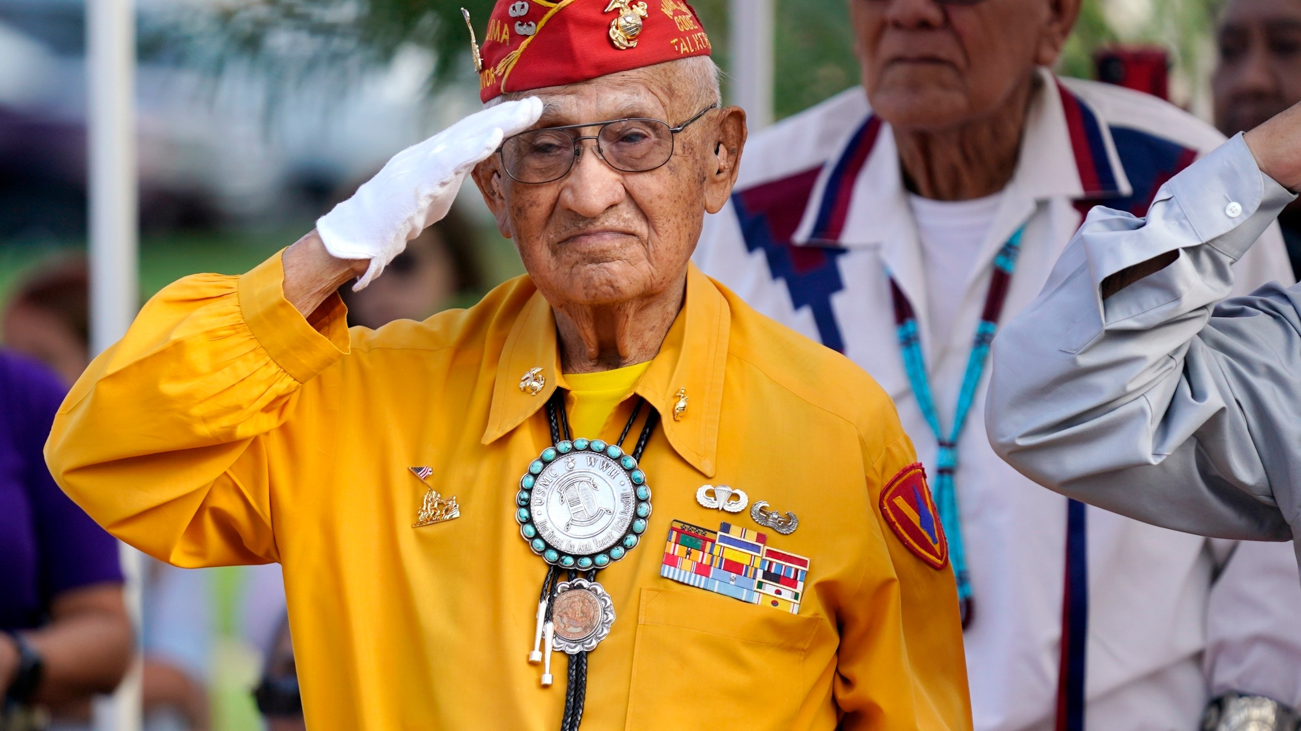 FILE - Navajo Code Talker Thomas Begay salutes during the national anthem at the Arizona State Navajo Code Talkers Day celebration, Aug. 14, 2022, in Phoenix. (AP Photo/Ross D. Franklin, File)