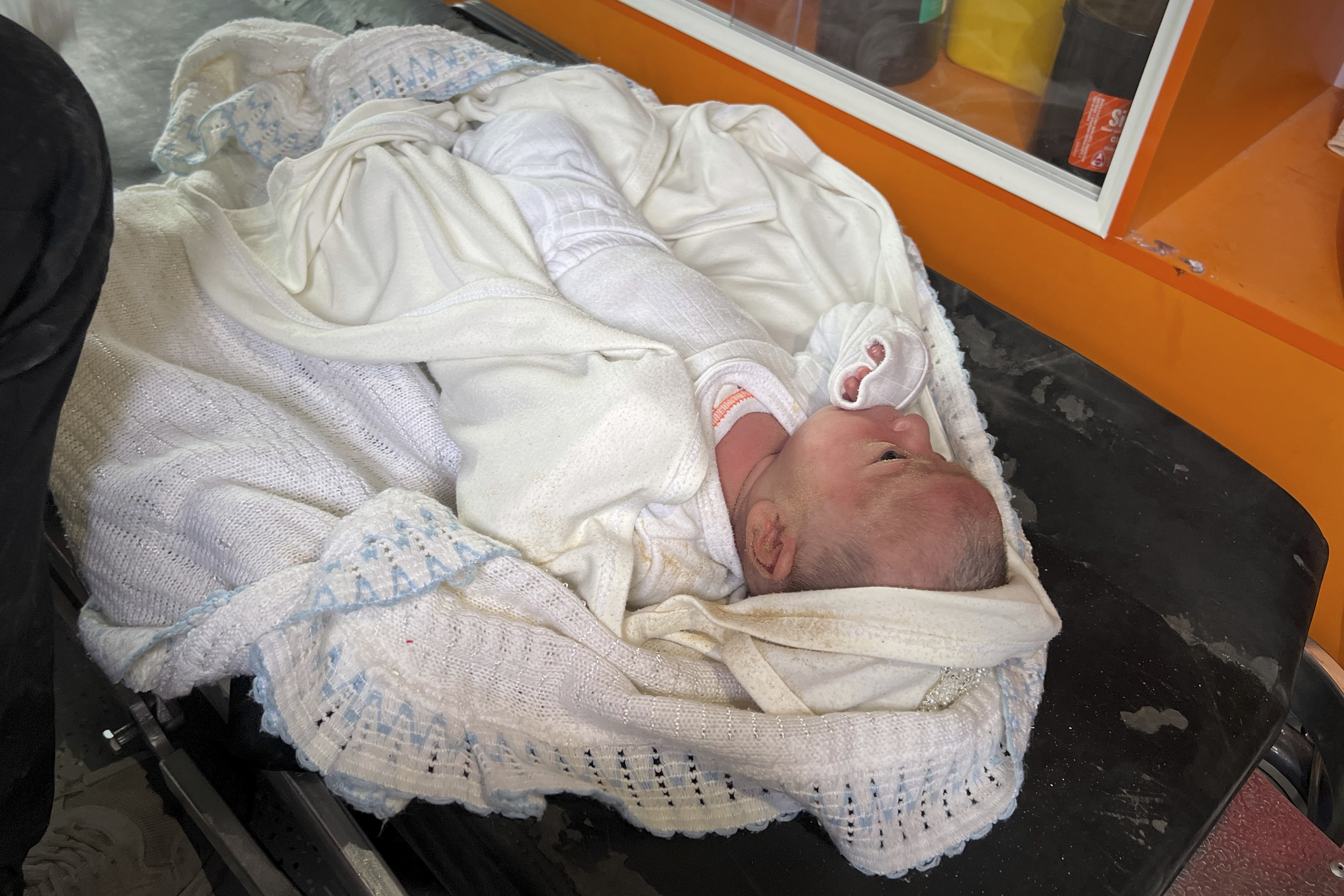 Ella Osama Abu Dagga, 25 days old, lies in a van after being pulled from the rubble following an Israeli army airstrike that killed her parents and brother in Khan Younis, southern Gaza Strip, Thursday, March 20, 2025. (AP Photo/Mariam Dagga)