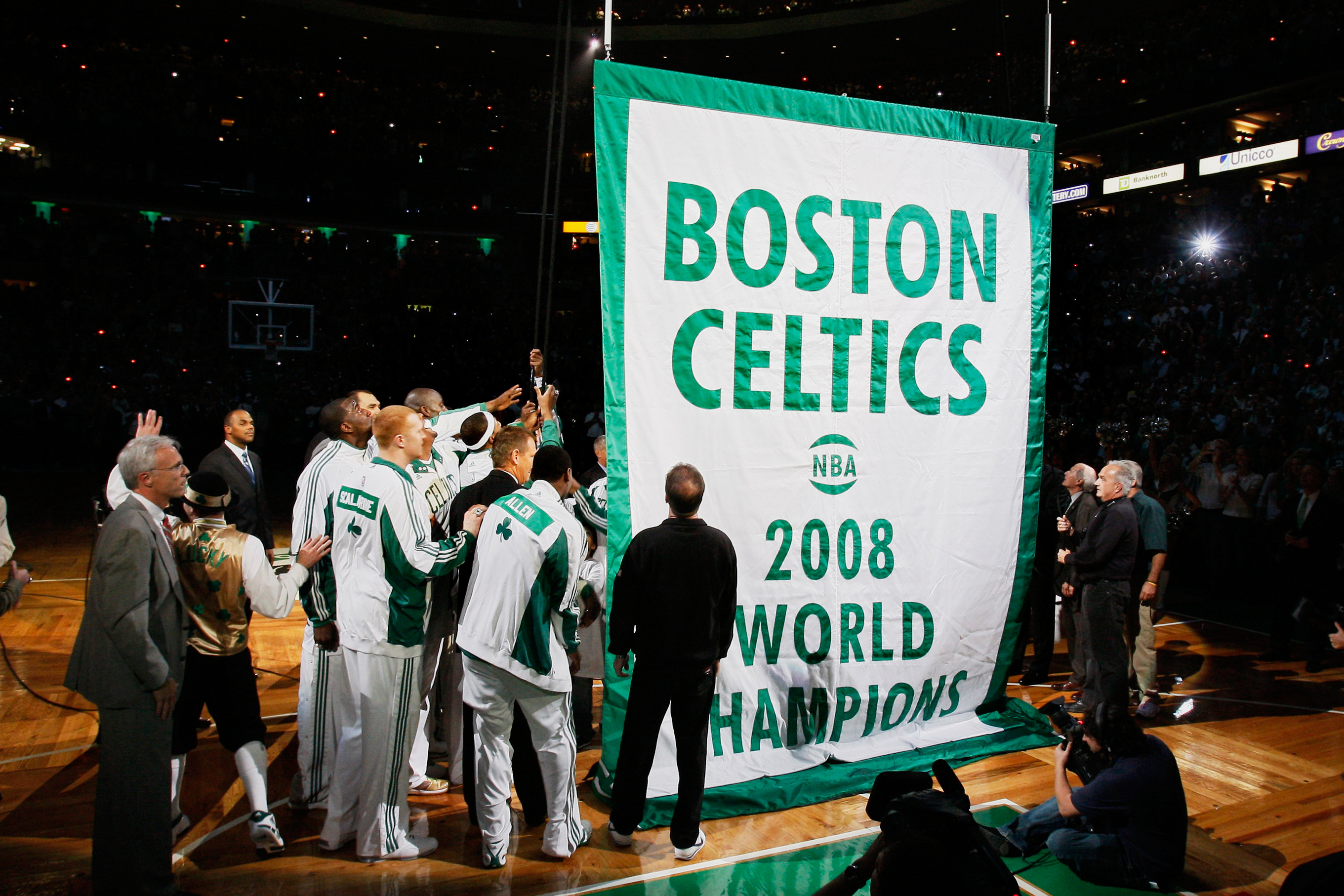 FILE - Boston Celtics players and team personnel gather to raise the Celtics' 17th NBA championship banner during ceremonies prior to an NBA basketball game against the Cleveland Cavaliers in Boston on Tuesday, Oct. 28, 2008. (AP Photo/Winslow Townson, File)