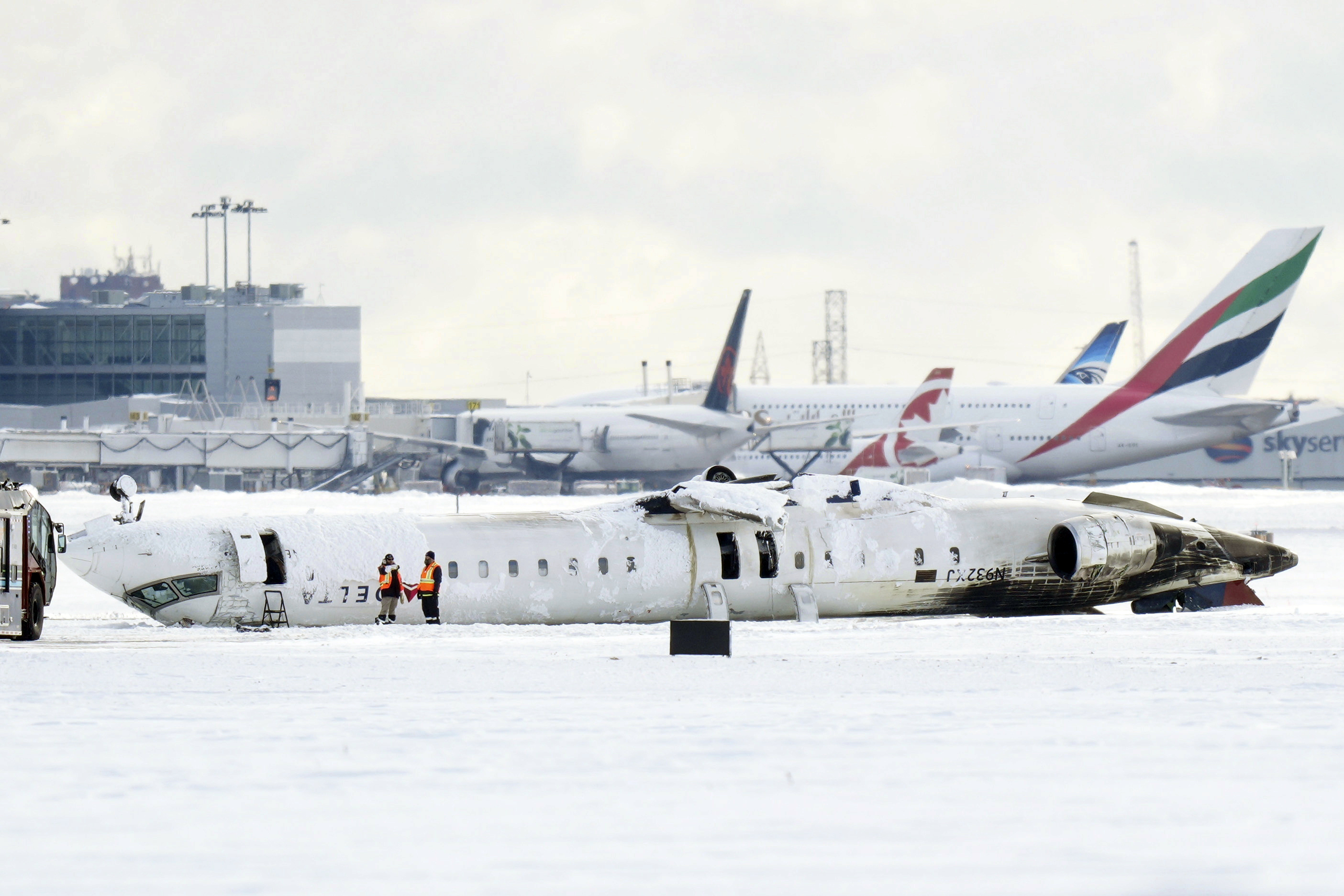 A Delta Air Lines plane lies upside down at Toronto Pearson Airport on Tuesday, Feb. 18, 2025. (Chris Young/The Canadian Press via AP)