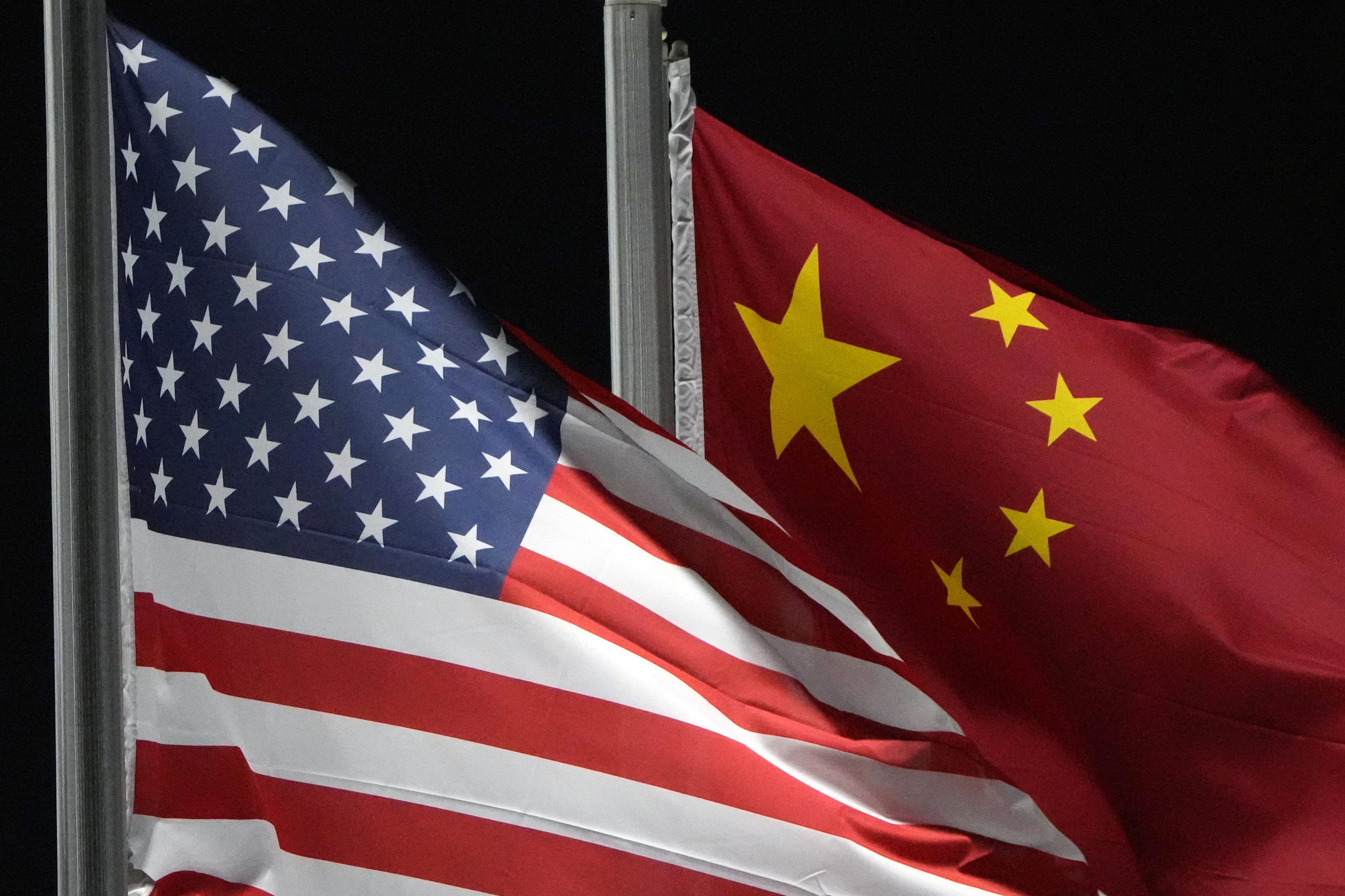 FILE - U.S. and Chinese flags wave at Genting Snow Park, Feb. 2, 2022, in Zhangjiakou, China. (AP Photo/Kiichiro Sato, File)