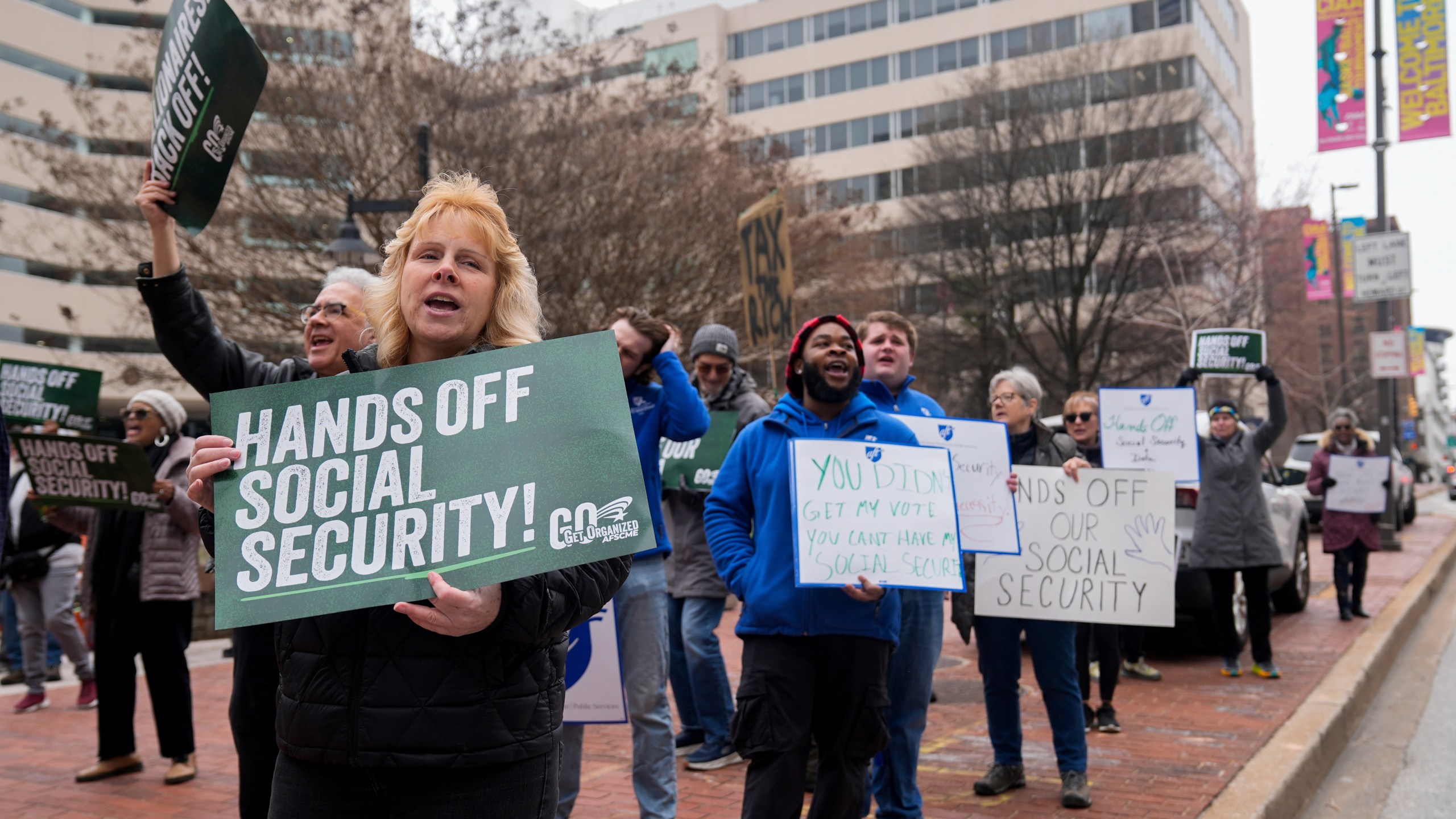 Demonstrators gather outside of the Edward A. Garmatz United States District Courthouse in Baltimore, on Friday, March 14, 2025, before a hearing regarding the Department of Government Efficiency's access to Social Security data. (AP Photo/Stephanie Scarbrough)