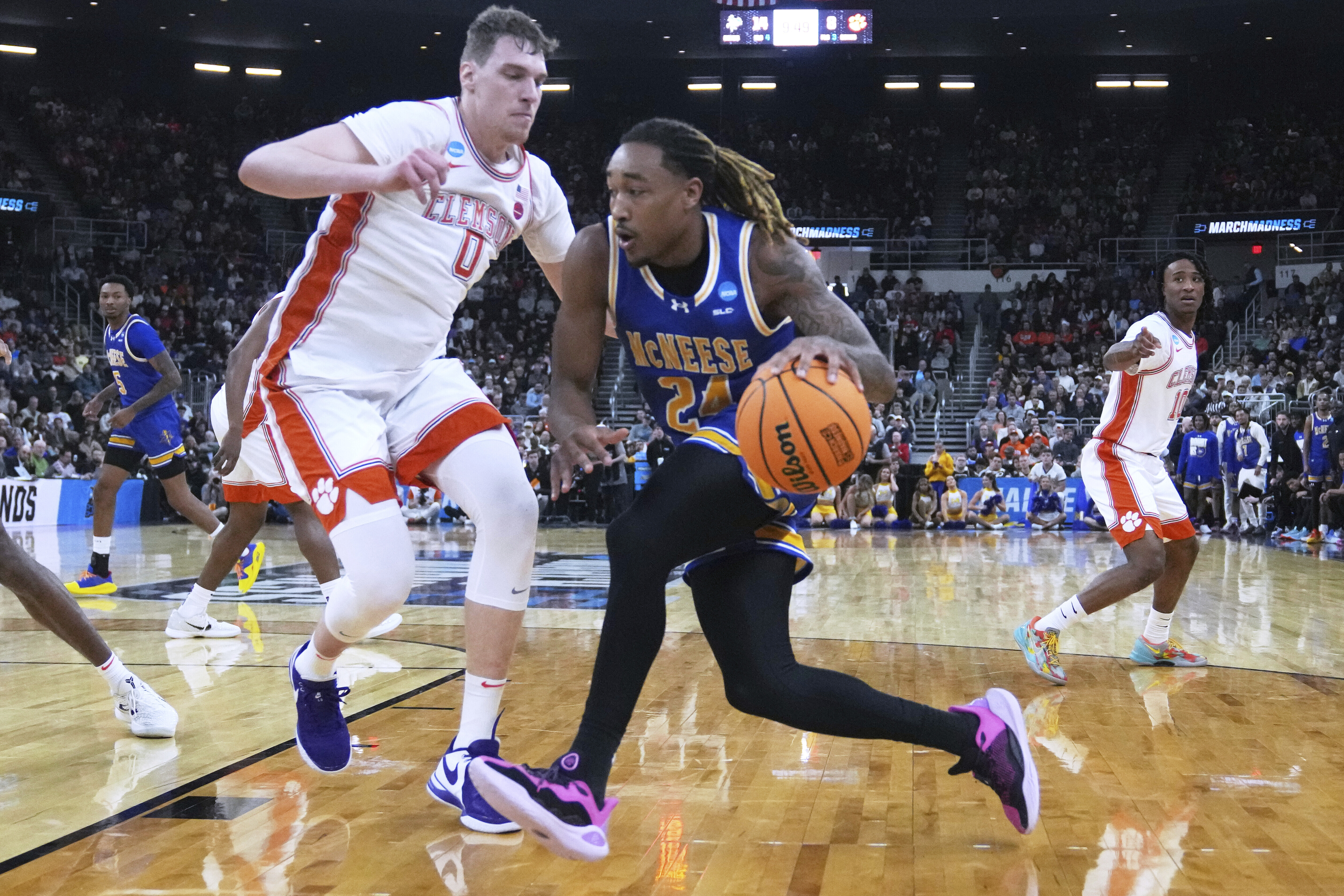 McNeese State forward Christian Shumate (24) drives to the basket past Clemson center Viktor Lakhin (0) during the first half in the first round of the NCAA college basketball tournament, Thursday, March 20, 2025, in Providence, R.I. (AP Photo/Charles Krupa)