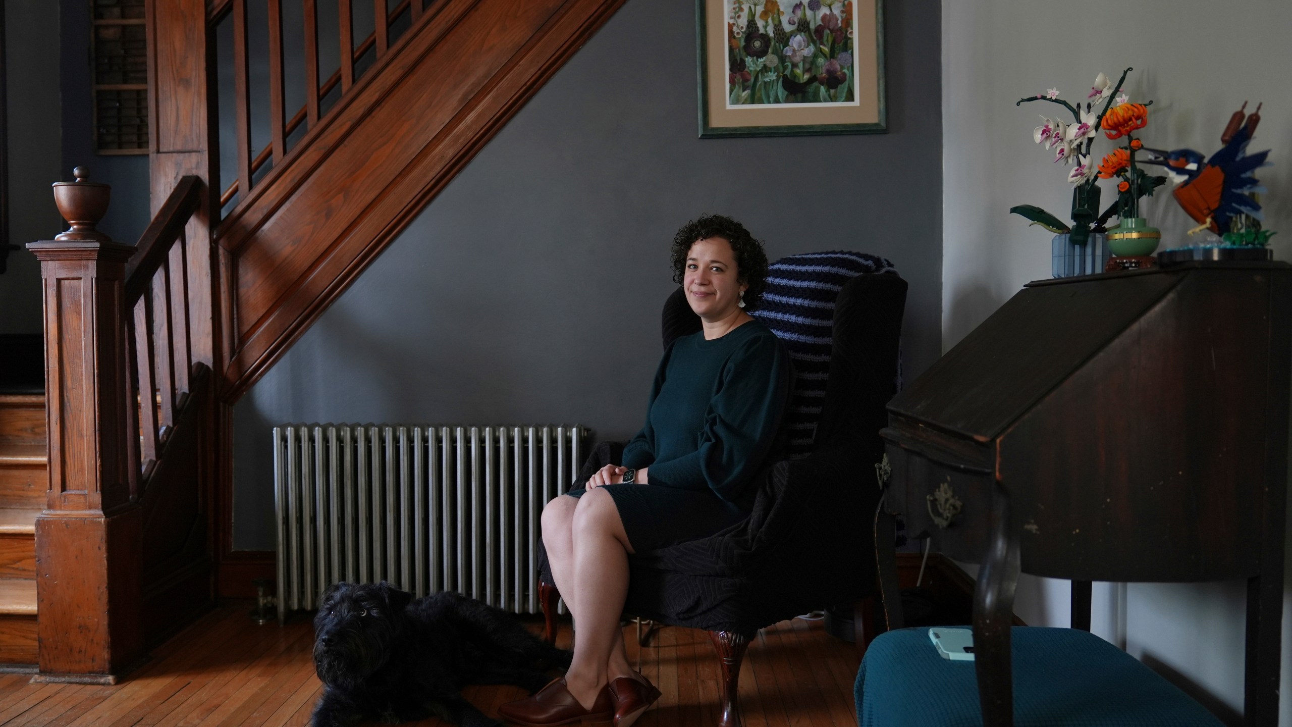 Hannah Jones, accompanied by her dog, Atlas, poses for a portrait at home near Philadelphia, Wednesday, March 12, 2025. (AP Photo/Matt Rourke)