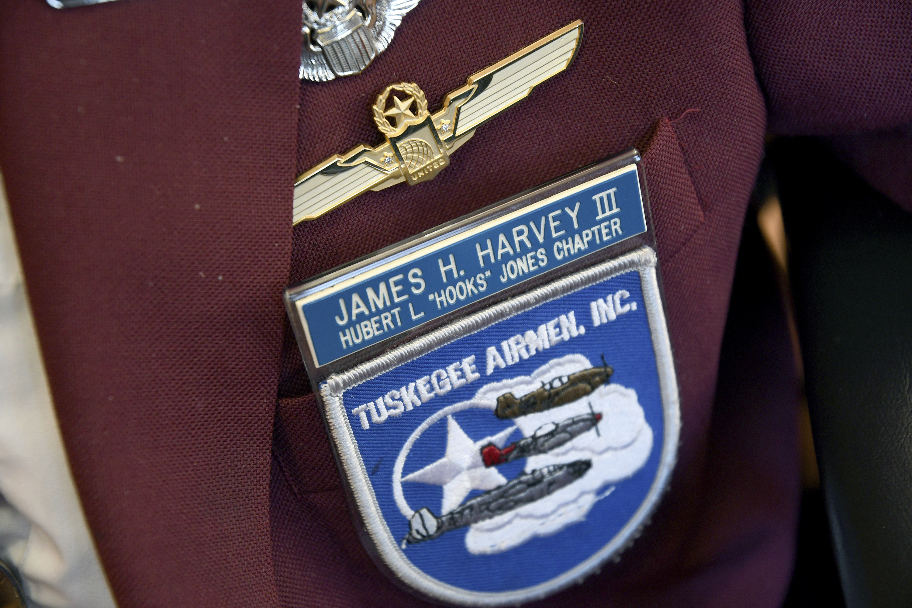 101-year-old Col. James H. Harvey III, one of the last surviving Tuskegee Airmen, wears a jacket adorned with pins and patches at the Veterans Community Living Center in Aurora, Colo., Wednesday, March 12, 2025. (AP Photo/Thomas Peipert)