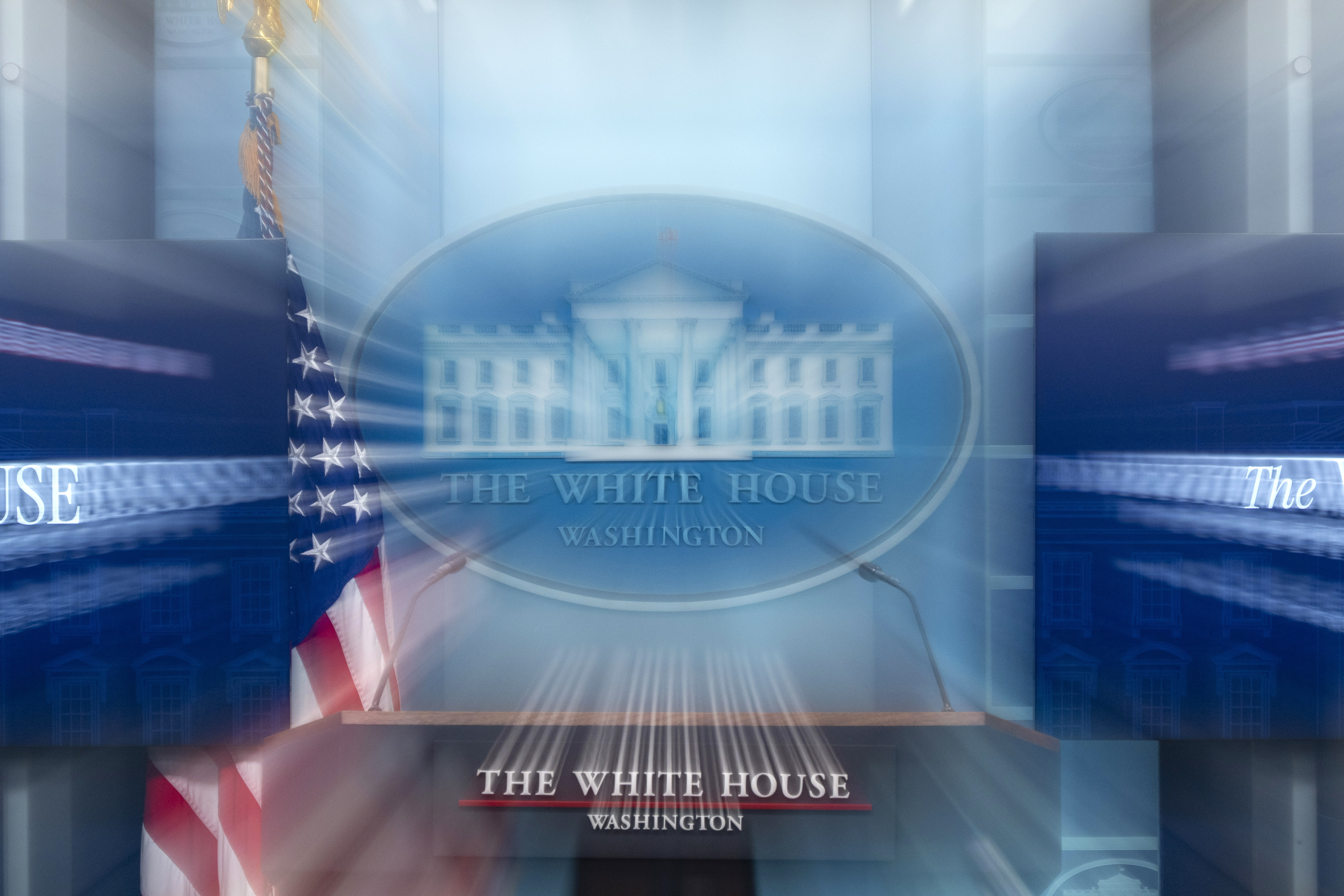 FILE - In this photo made with a slow shutter speed, the White House podium is seen before a briefing in the James Brady Press Briefing Room at the White House, March 5, 2025, in Washington. (AP Photo/Alex Brandon, File)