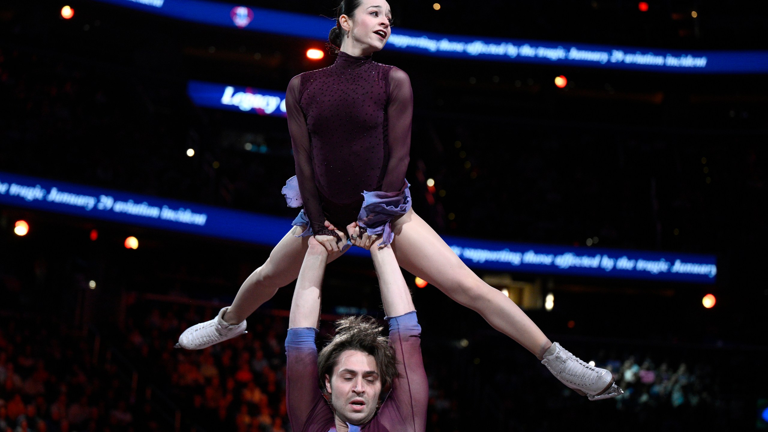 Katie McBeath, top, and Daniil Parkman perform Sunday, March 2, 2025, in Washington, at the Legacy on Ice event, a figure skating tribute to support the families and loved ones affected by the Jan. 29 aviation incident. (AP Photo/Nick Wass)