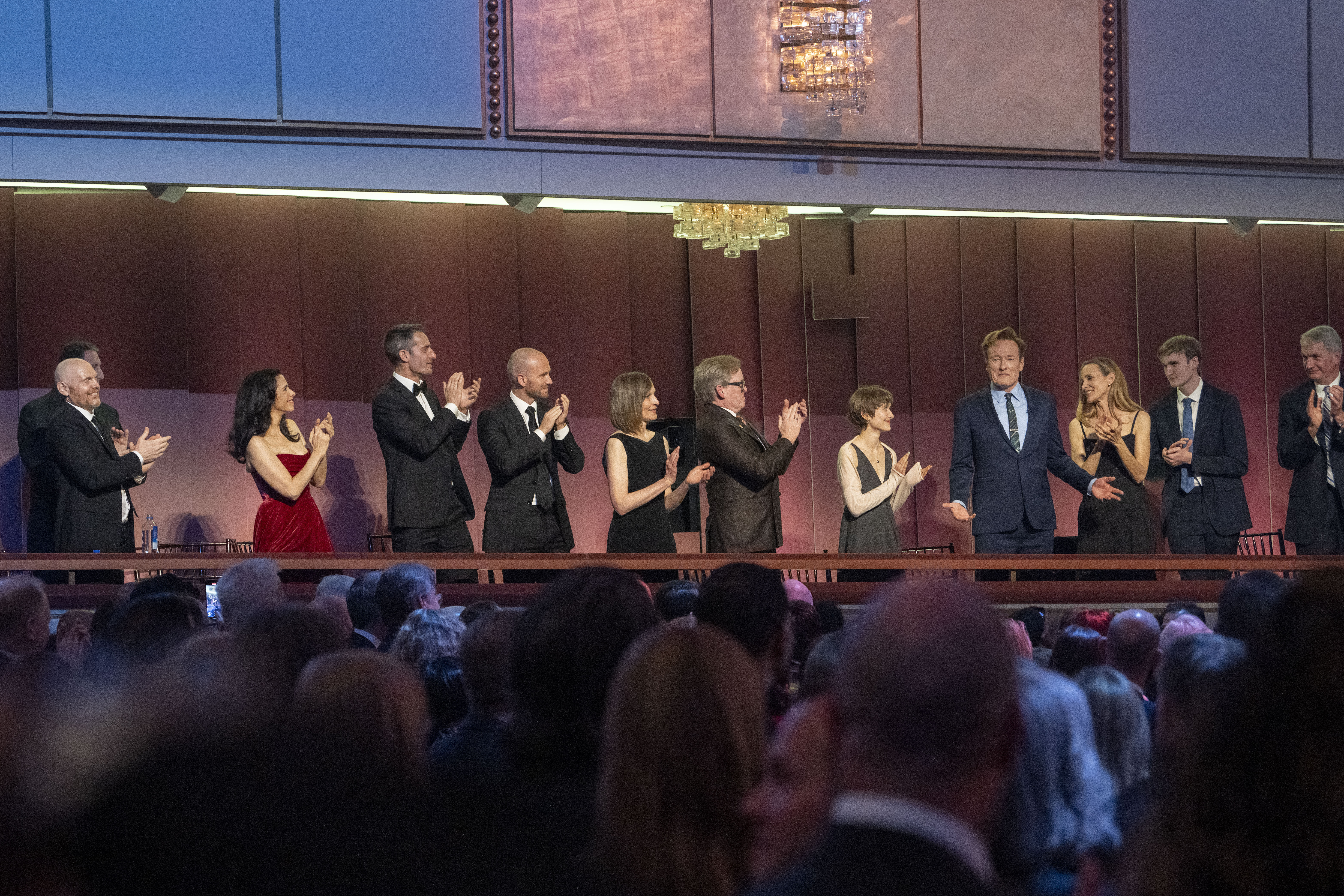 Comedian Conan O'Brien, fourth from right, is applauded as he takes his seat at the start of the 25th Annual Mark Twain Prize for American Humor Celebrating Conan O'Brien, Sunday, March 23, 2025, at the Kennedy Center for the Performing Arts in Washington. (AP Photo/Kevin Wolf)