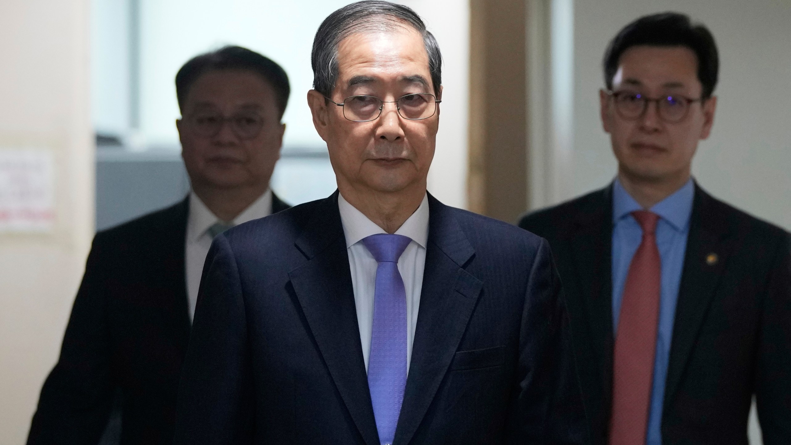 South Korean acting President Han Duck-soo, center, arrives to hold a briefing at the Government Complex in Seoul, South Korea, Monday, March 24, 2025. (AP Photo/Ahn Young-joon, Pool)