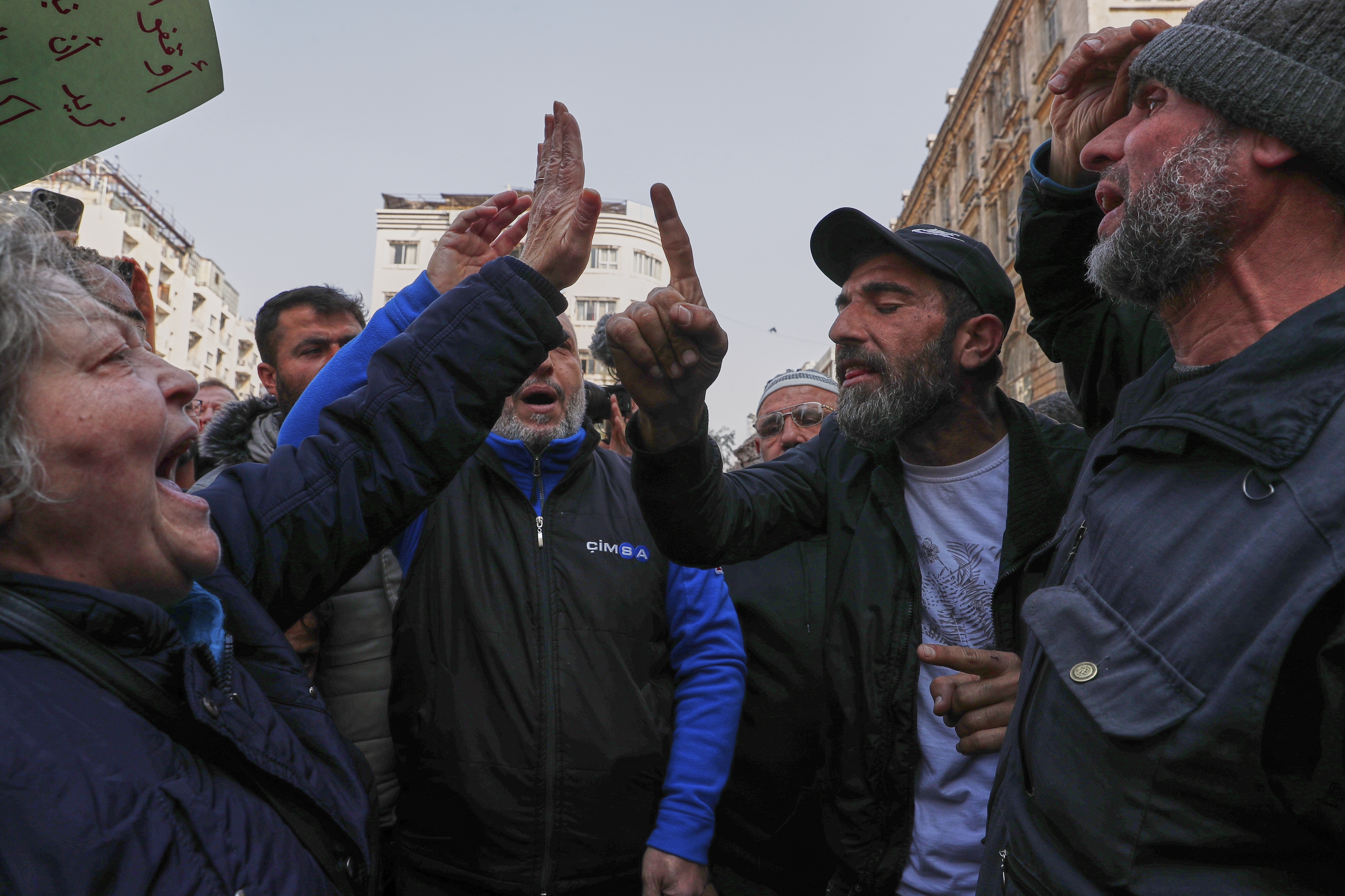 An activist woman protesting against the recent wave of violence and sectarian attacks in Syria's coastal region faces off against a man at Al Marjeh Square in Damascus, Syria, Sunday, March 9, 2025. (AP Photo/Omar Sanadiki)