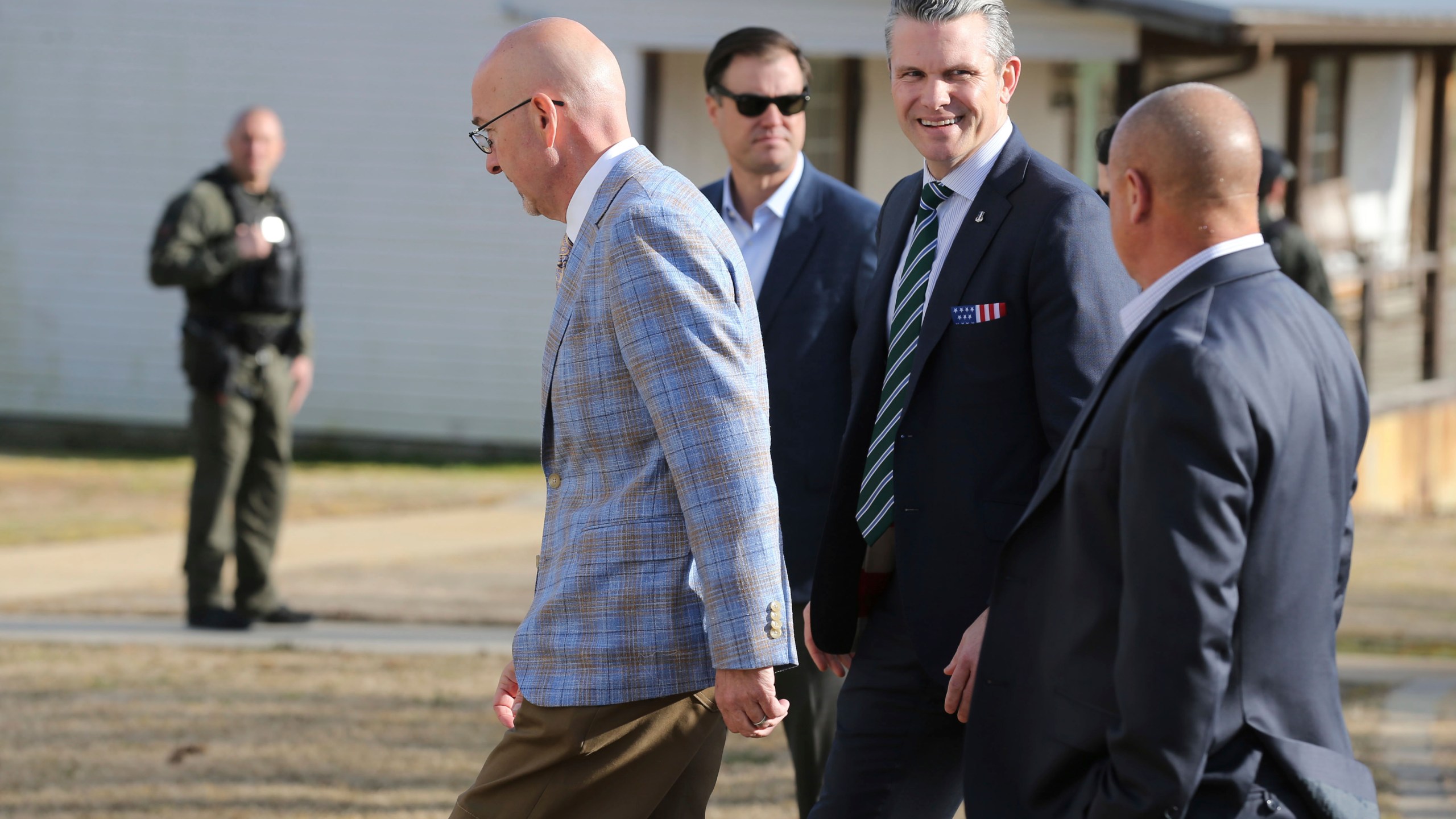 Secretary of Defense Pete Hegseth, center, walks with Scott Burns, left, as they enter "A Southern Salute to the Troops" fund raiser put on by the non-profit 7 Days for the Troops Thursday, March 20, 2025, in Tupelo Miss. (Thomas Wells /The Northeast Mississippi Daily Journal via AP)