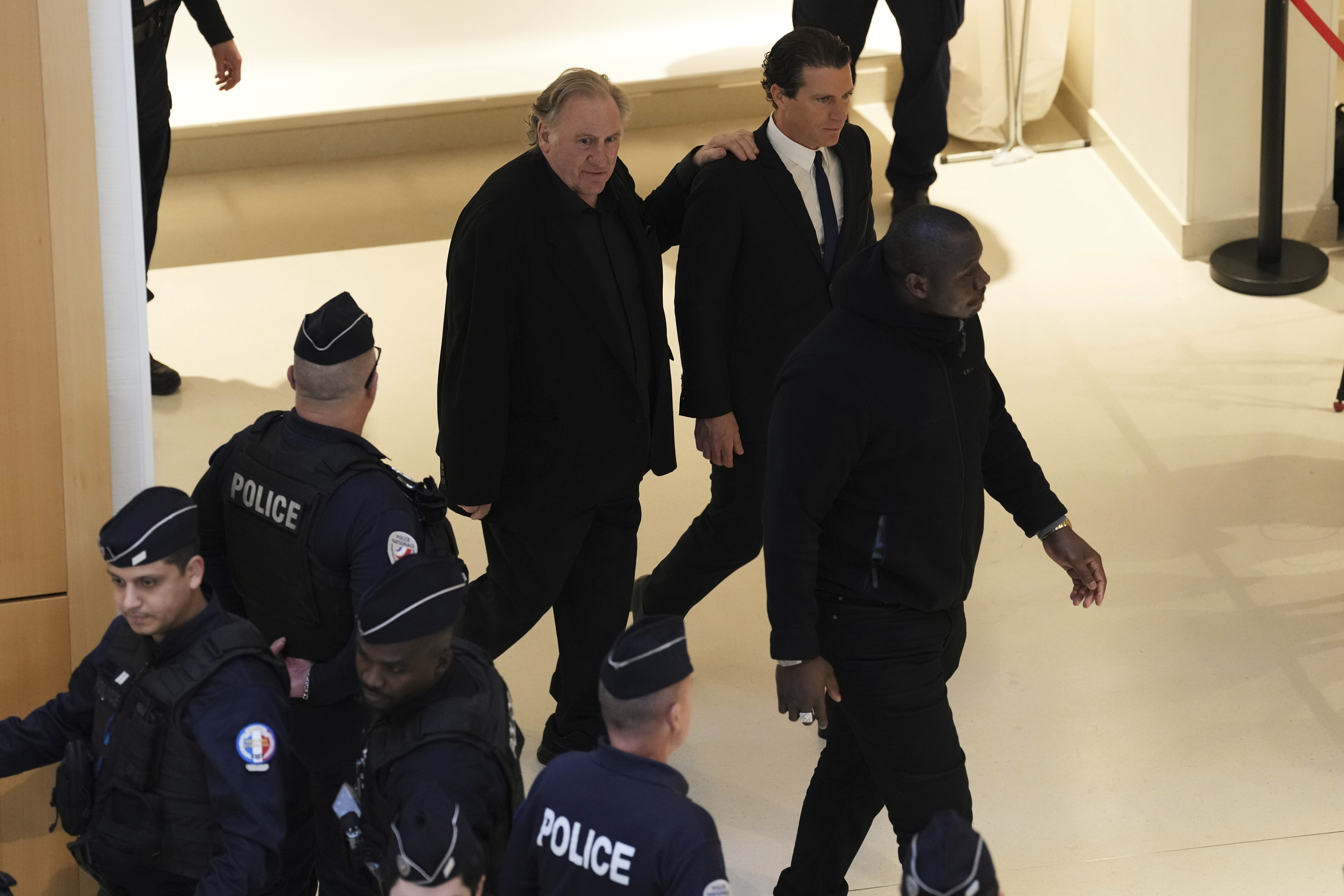 Actor Gerard Depardieu returns ti the court with his lawyer Jeremie Assous during his trial for the alleged sexual assaults of two women on a film set in 2021, Tuesday, March 25, 2025 in Paris. (AP Photo/Aurelien Morissard)