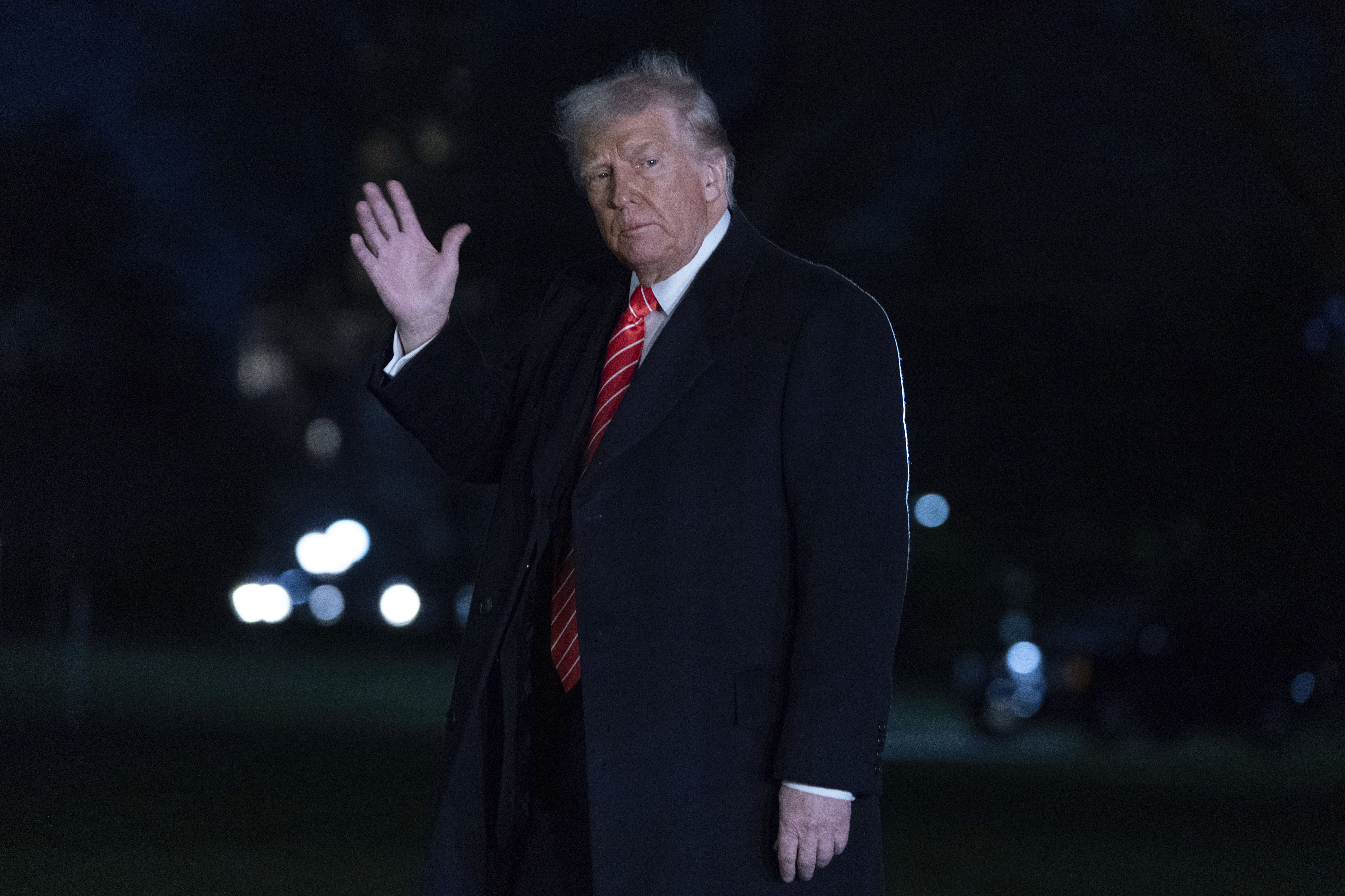 President Donald Trump waves to the media as he walks on the South Lawn of the White House, in Washington, Saturday, March 22, 2025. (AP Photo/Jose Luis Magana)